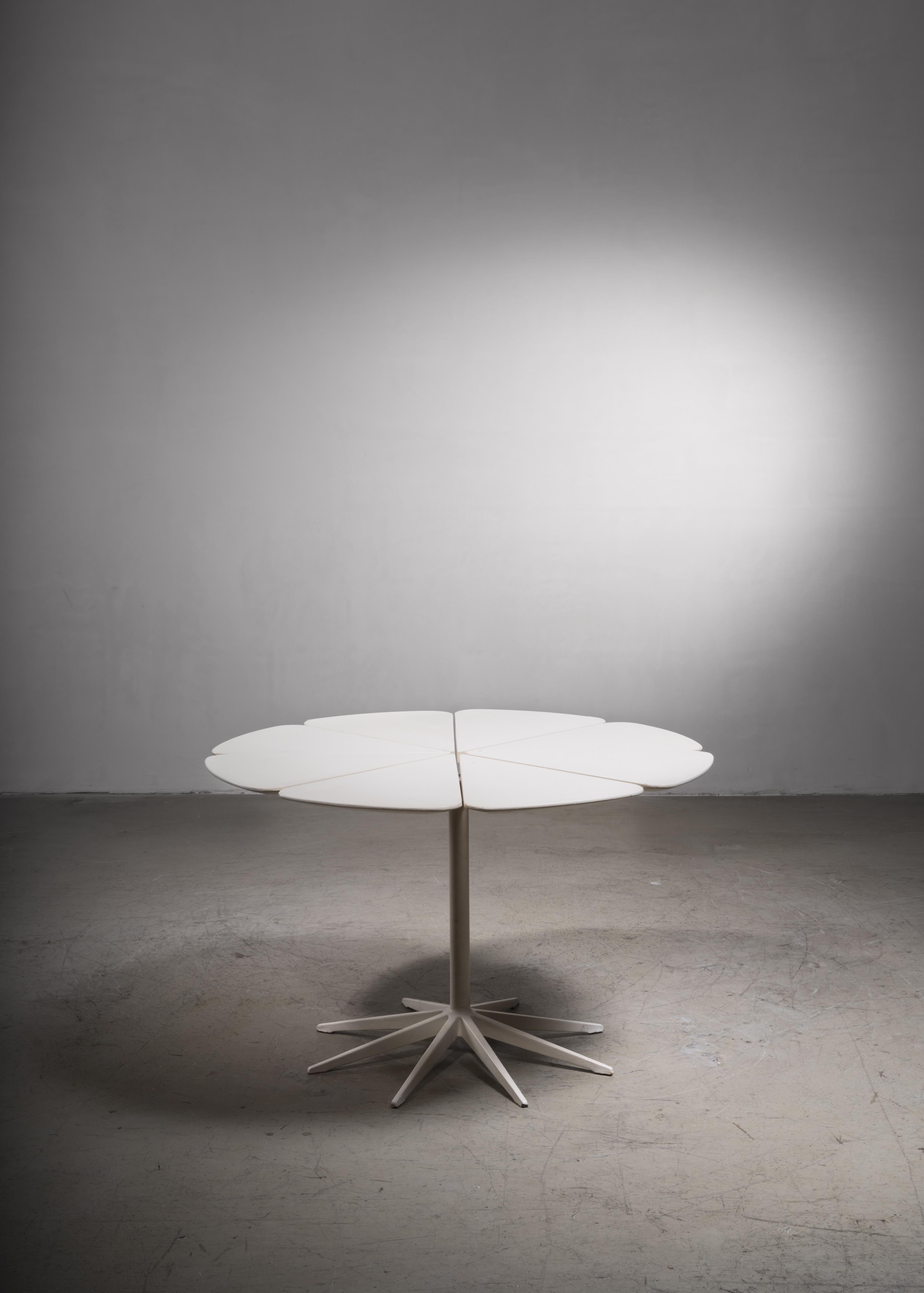A white petal dining table by Richard Schultz for Knoll. The table is made of eight wooden petal-like pieces, mounted on an aluminum 'spider.' The petal dining table was a collaboration of Richard Schultz with Knoll International. He designed this
