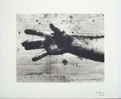 STILL FROM HAND CATCHING LEAD, by Richard Serra ( a black and white hand covered
