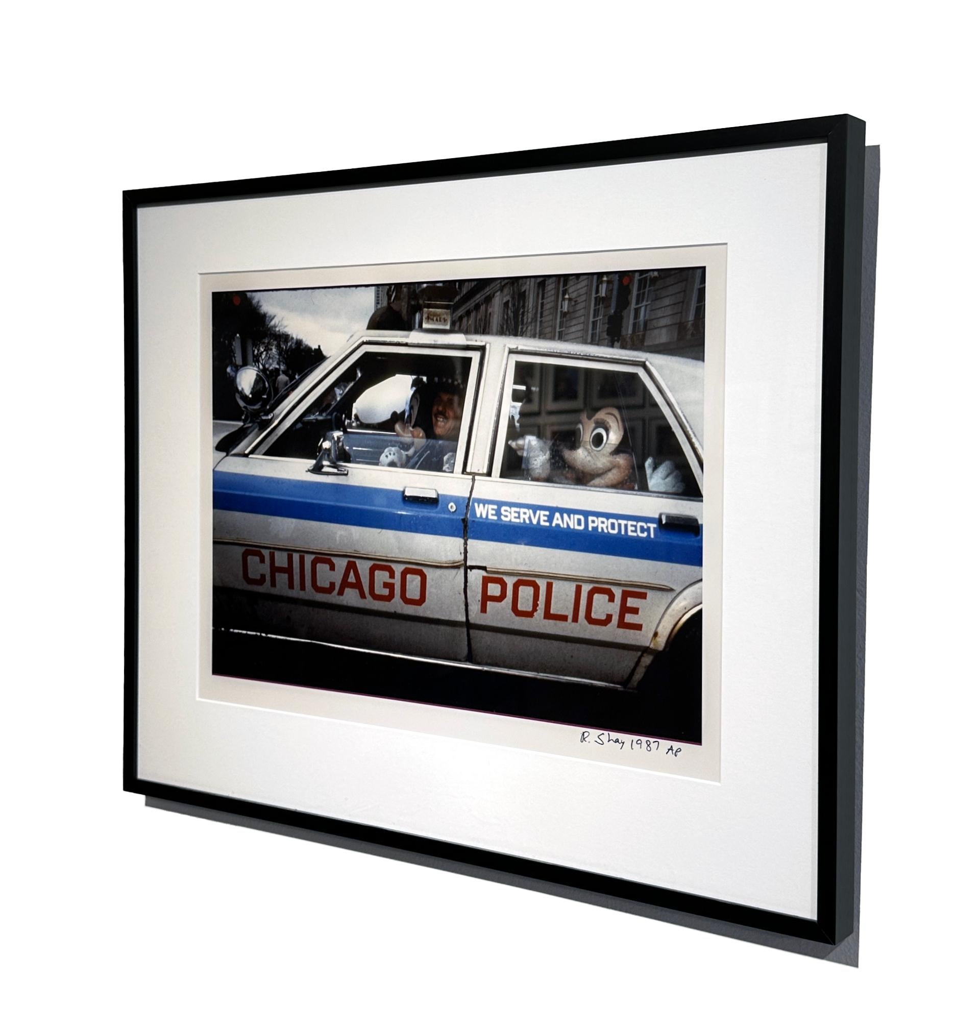 Something not seen every day is Minnie Mouse in the back of a police car!  And with a closer look, Mickey Mouse is in the front seat.  Richard Shay captured this image in 1987 in downtown Chicago. This Artist Proof is matted and framed in a simple