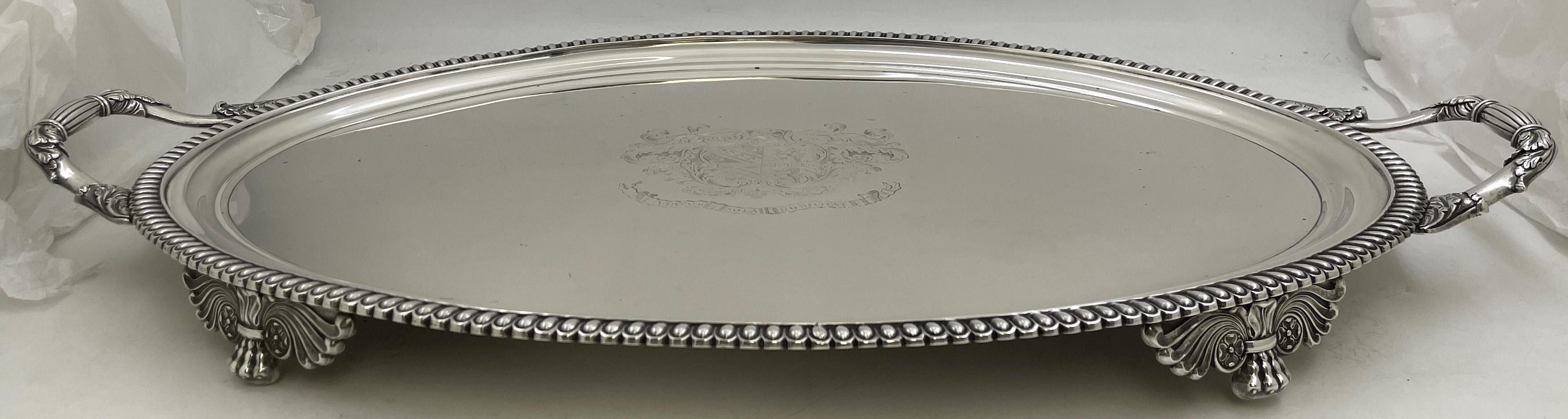 Richard Sibley, English sterling silver Georgian tray from 1814 with a gadrooned rim, with handles adorned with stylized natural motifs, standing on 4 feet.  It measures 26 1/2'' in length from handle to handle (22 1/4'' excluding the handles) by