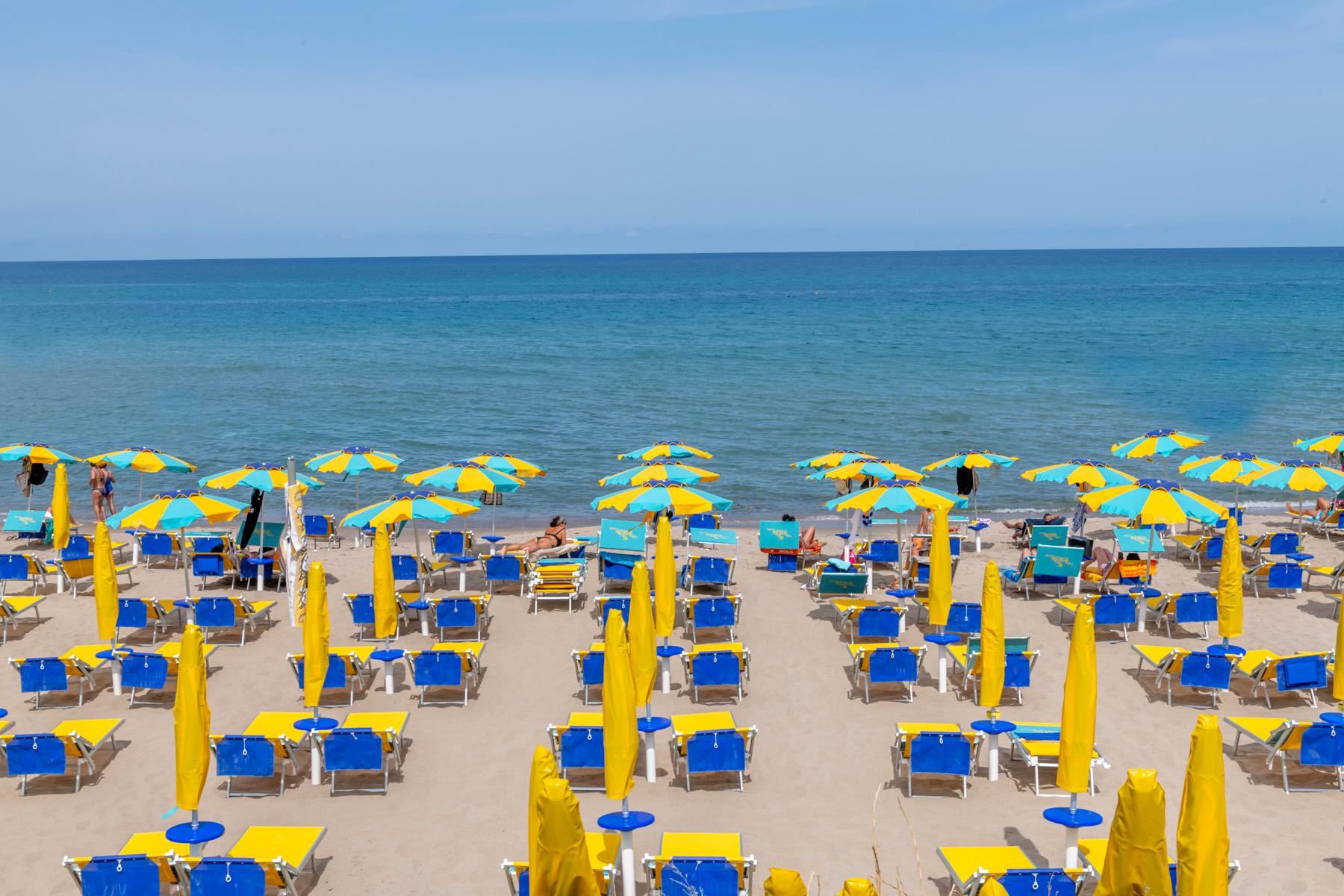 Blue yellow parasols - color photography - Photograph by Richard Silver