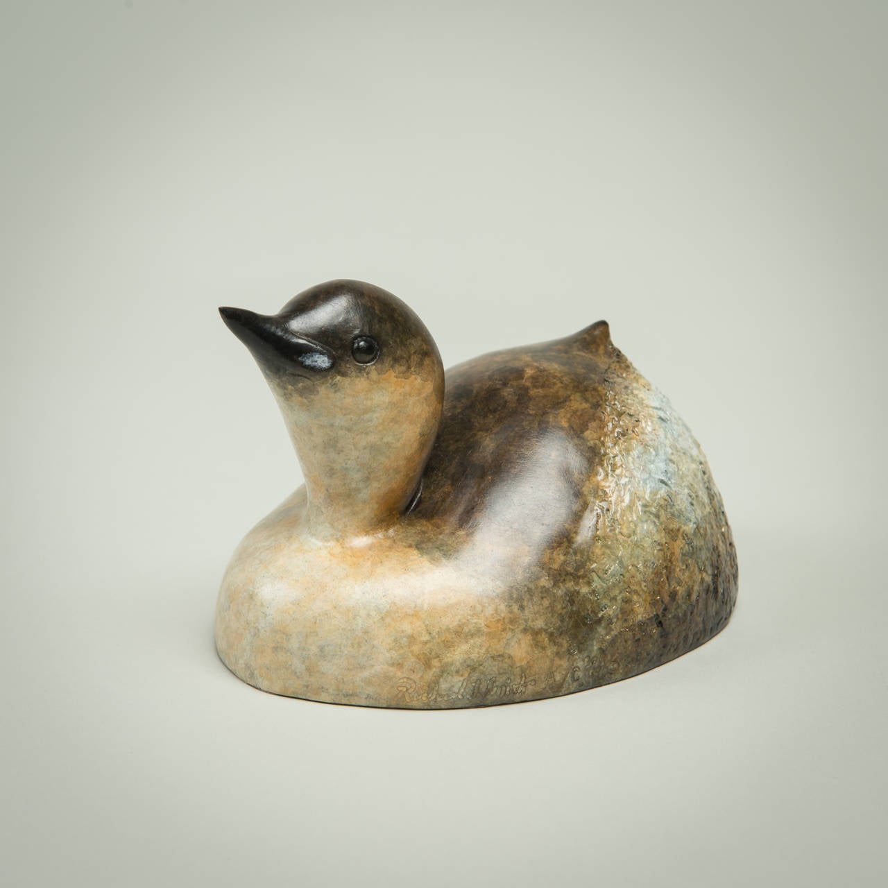'Dabchick' is a solid Bronze sculpture with a stunning patination. Richard Smith's ability to convey so much character with such simple lines is a testament to the knowledge and love the artist has of the animals he sculpts.

 Richard J. Smith was