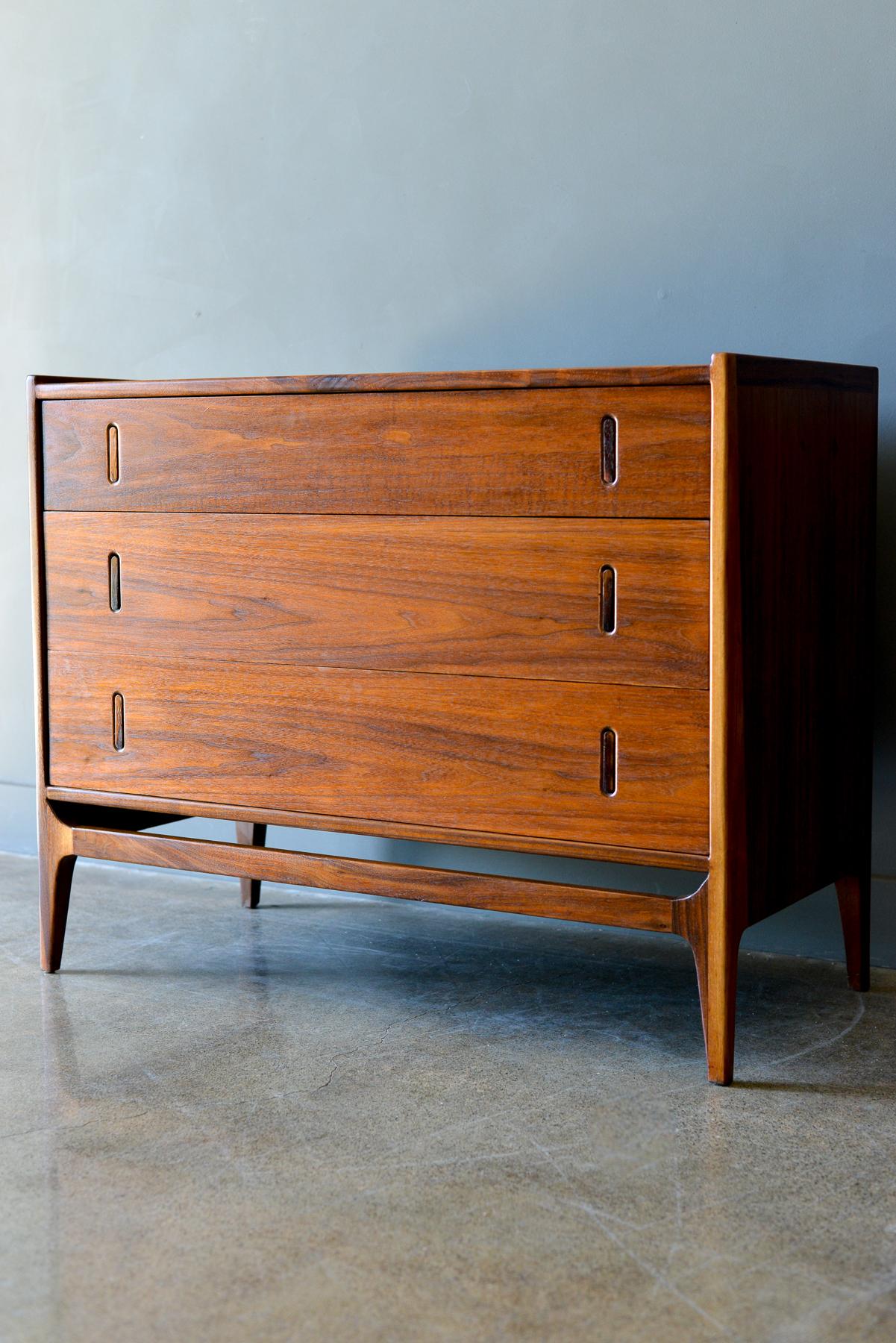 Richard Thompson for Glenn of California 3 drawer chest or cabinet, ca. 1960. Beautiful walnut grain with delicate rocking rosewood pulls on drawers. Could be used as a small dresser or nightstand. Measures 38