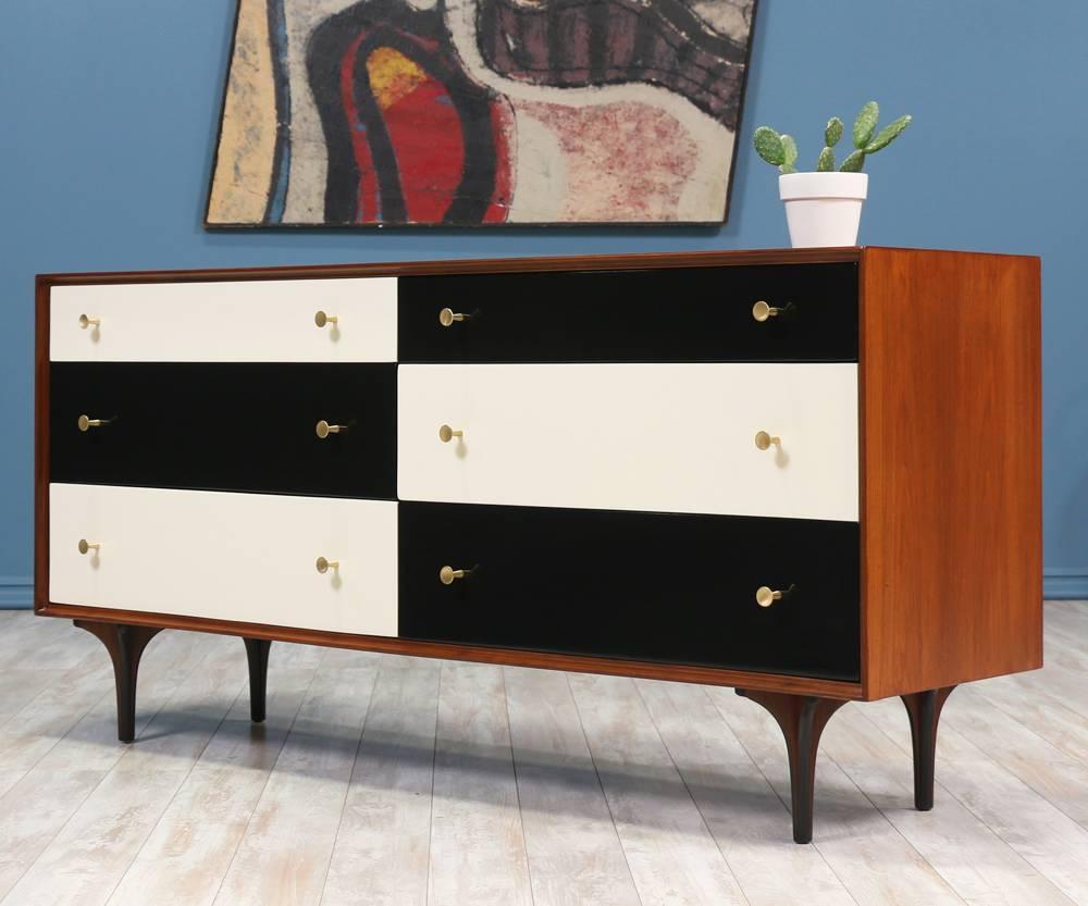 Dresser manufactured in the United States and designed by Richard Thompson for Glenn of California circa 1950’s. The playful colors and shape of the bentwood legs contrast beautifully with the simple walnut wood case. The six drawers lacquered in