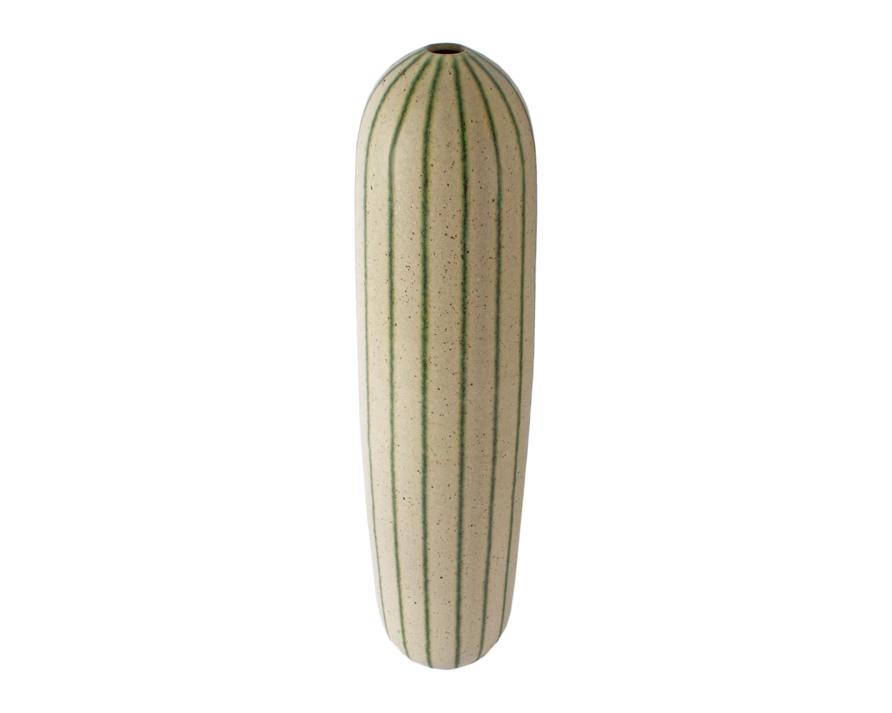 A studio pottery vase by American artist Richard Tuck (1948-2013). Signed to the underside, the oversized vase features a tall slender body. Green vertical stripes run the length of the vase over the creme speckled glaze. Signed “R. Tuck” to the