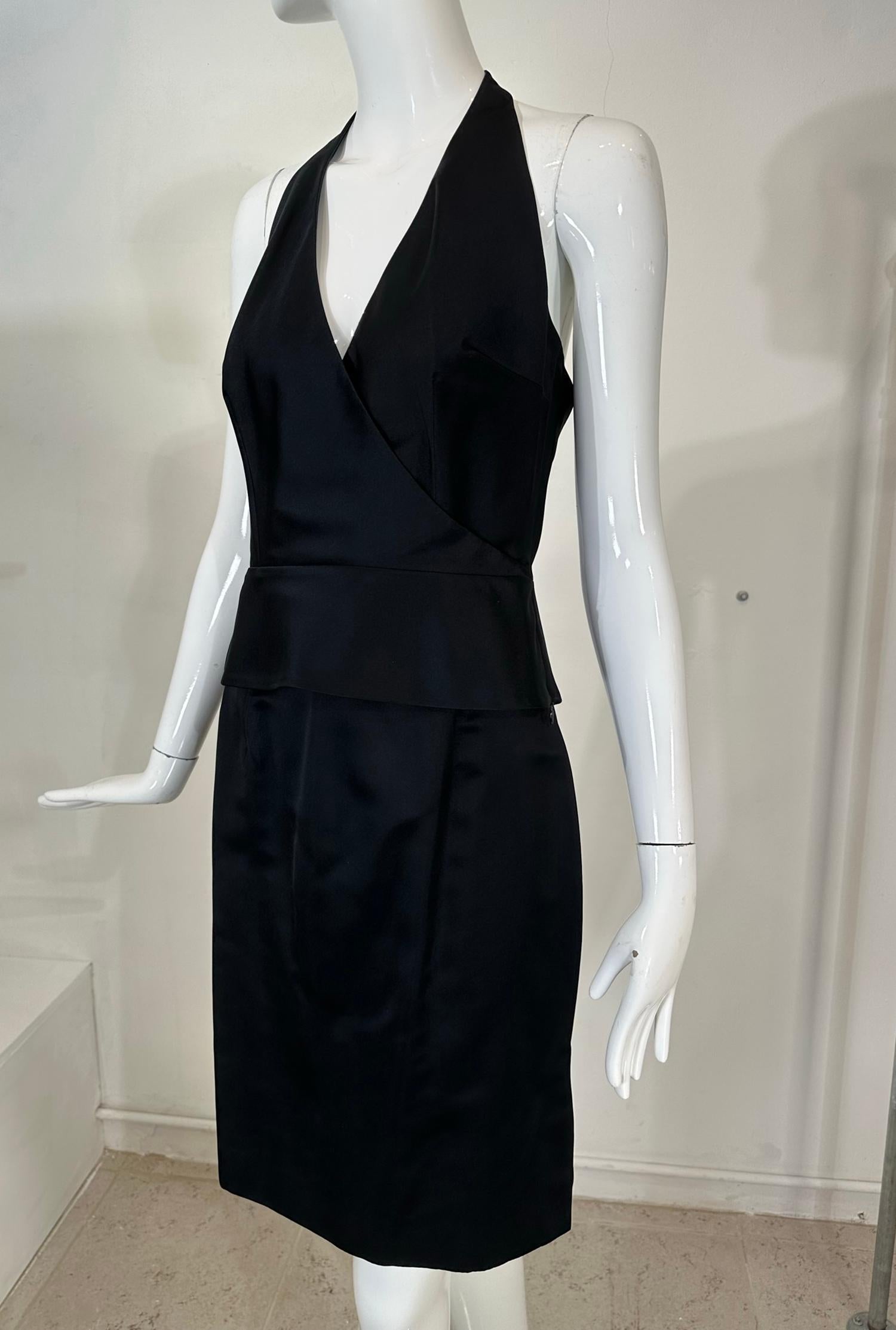 Richard Tyler Couture black silk satin halter neck, peplum hem top & matching pencil skirt with a center back hem vent, each marked size 6. From the early 2000s. The top has a surplice neckline, a seamed waist and a peplum hem, closing at the neck