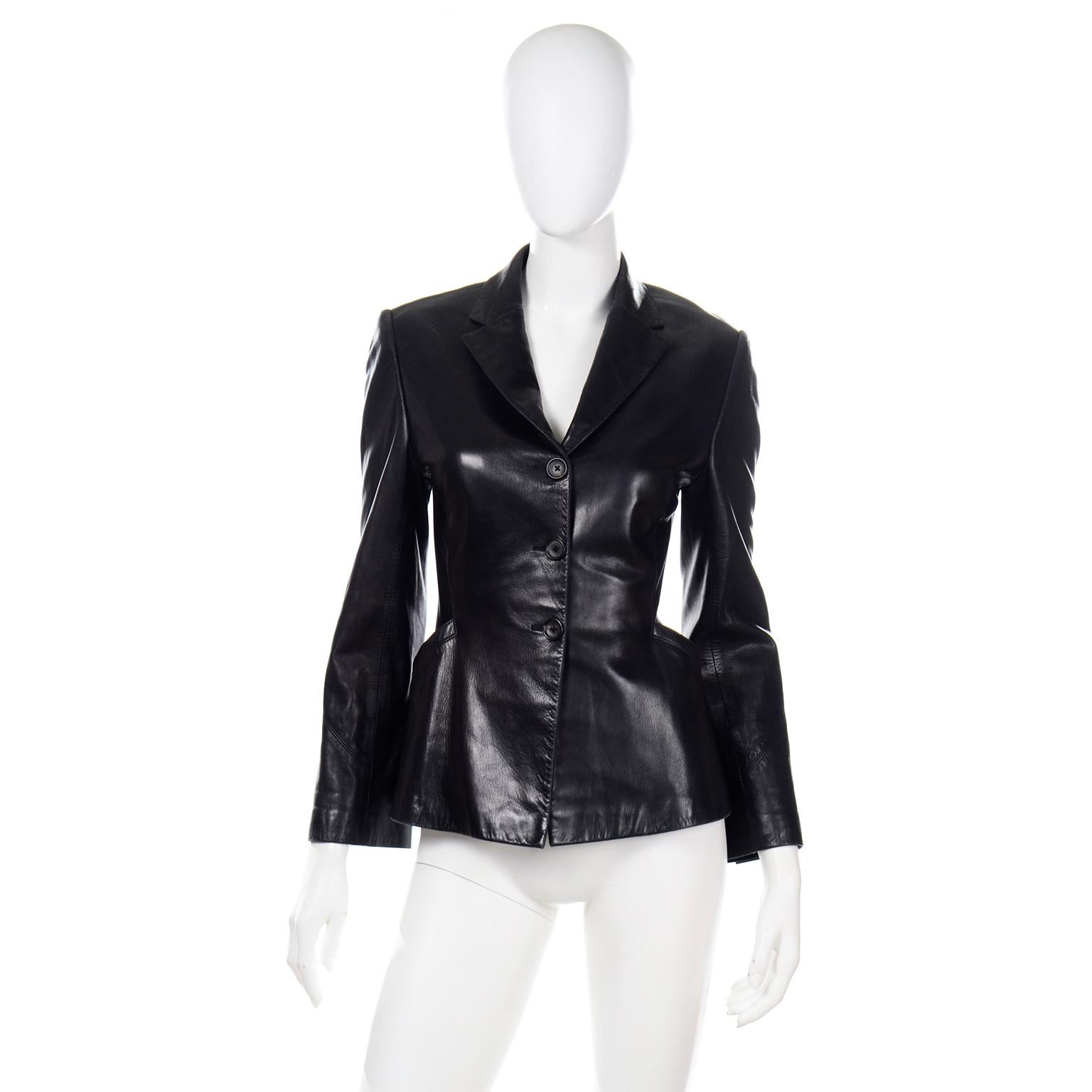 This is a super soft black leather Richard Tyler Couture vintage jacket. The jacket is styled like a blazer and has top stitched seams on the diagonal on the sleeves with diagonal slit pockets and a notched collar. The jacket buttons with 3 buttons