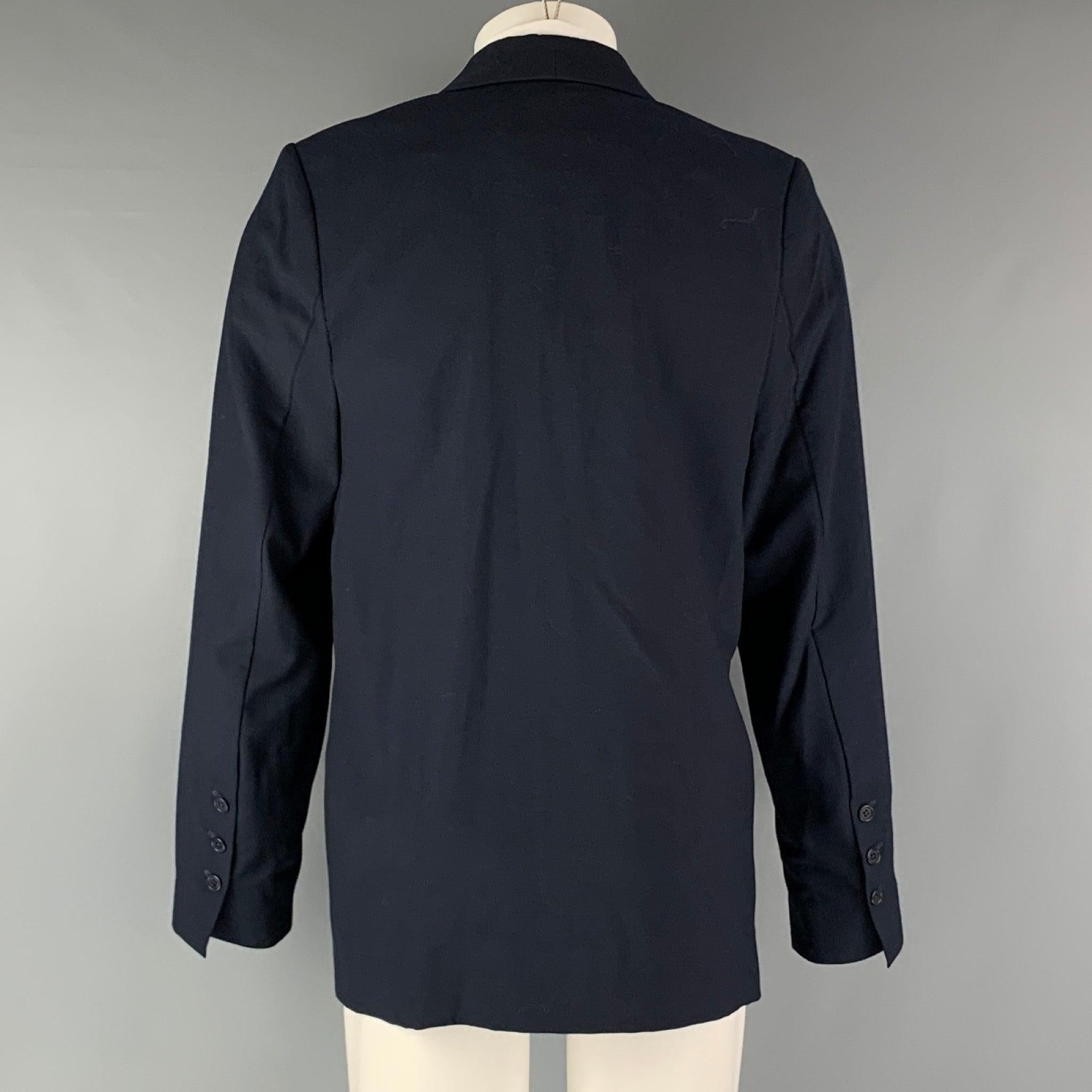 RICHARD TYLER sport coat comes in a navy wool woven material with a faille shawl collar and link closure. Made in USA.Very Good Pre-Owned Condition. 

Marked:   40 

Measurements: 
 
Shoulder:16 inches Chest: 40 inches Sleeve: 27.5 inches Length: 32