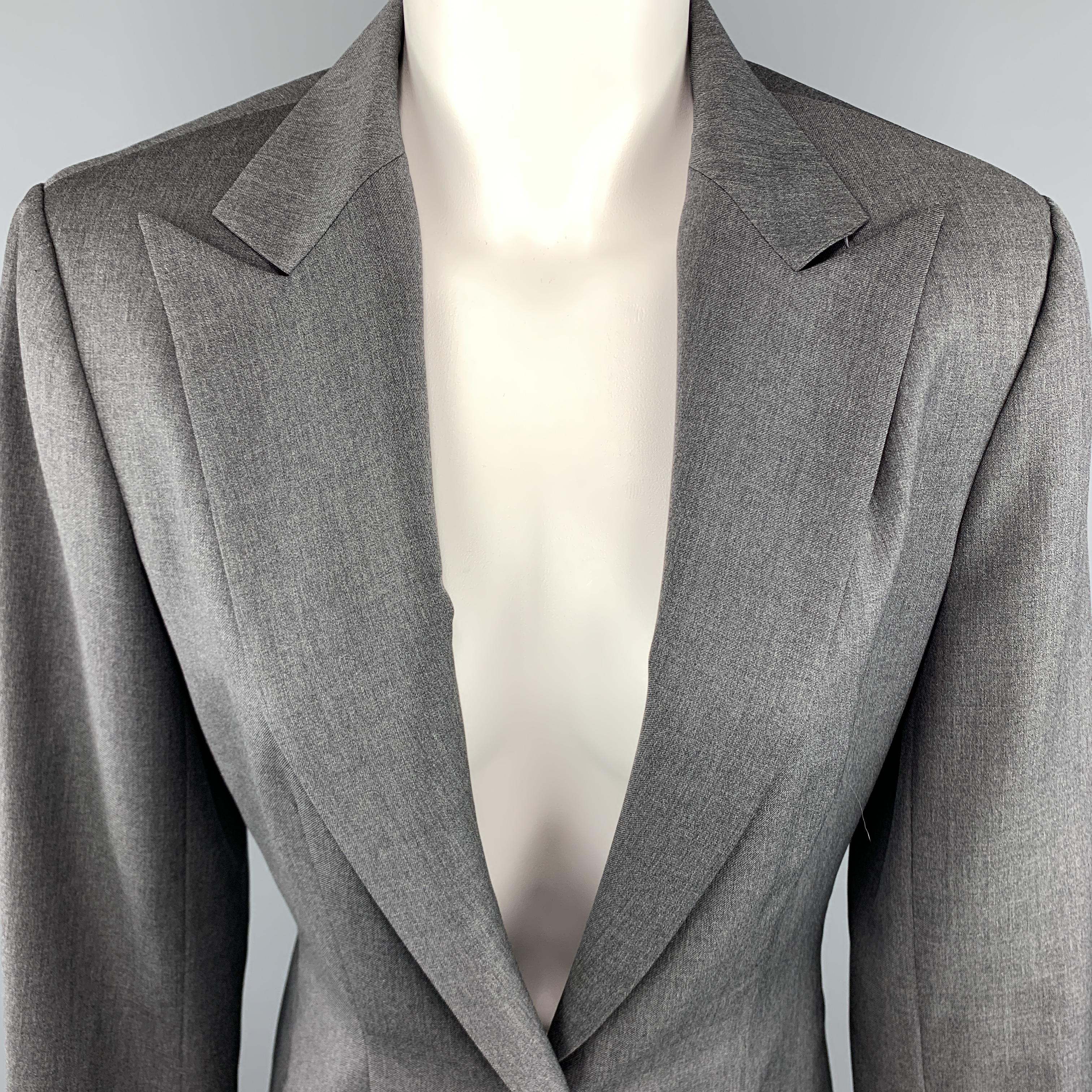 RICHARD TYLER Indoor Blazer comes in a grey tone in a solid gabardine material, with a peak lapel, a single button at closure, single breasted, with functional buttons at cuffs, a single vent at back, unlined. Minor wear at shoulder. Made in USA.
