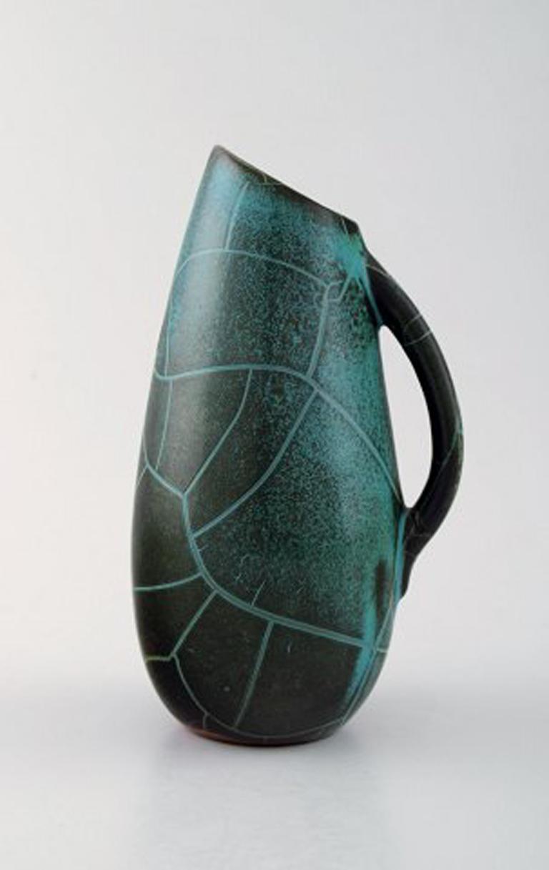 Richard Uhlemeyer, German ceramist.
Collection of ceramic jugs or vases, beautiful cracked glaze in red and green shades.
Germany, 1940s-1950s.
Largest measures 18 cm. x 9 cm.
In perfect condition.
Stamped.