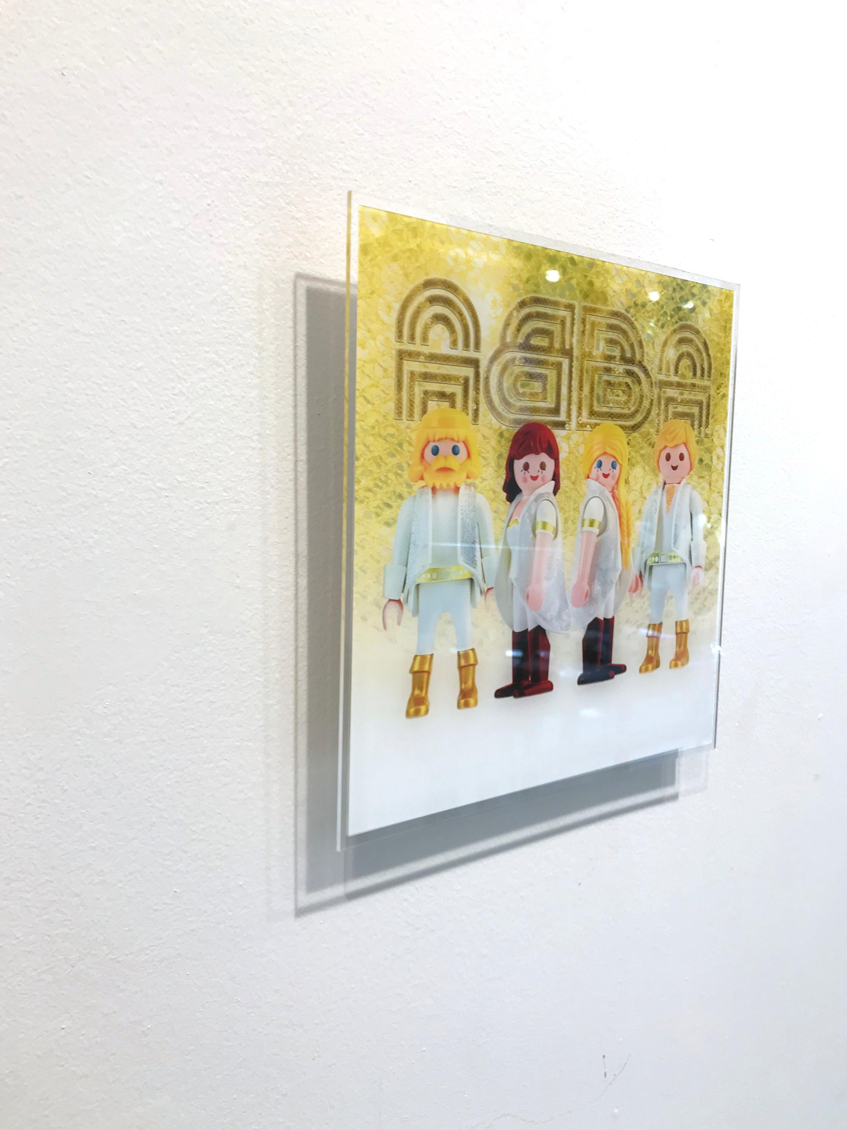 This limited edition photograph is created using Playmobil figurines arranged in a customized scene. In this piece, Unglik is inspired by ABBA, a Swedish pop group that formed in Stockholm in 1972. Edition of 15. It is signed on the back by the