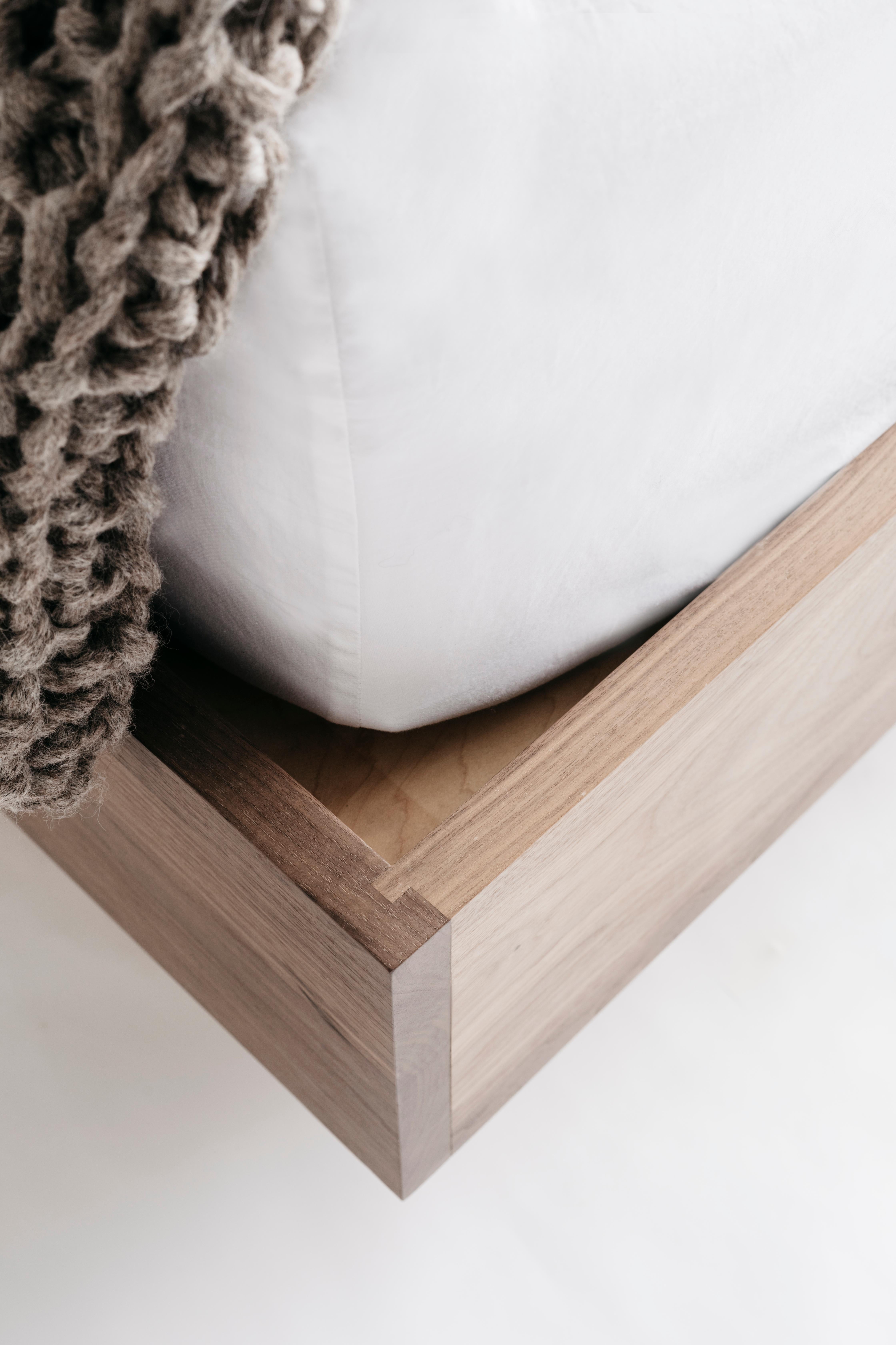 The Keepsake bed is handcrafted with discrete drawers and shelves that fit into the sides of the headboard like wooden puzzle pieces. The push-release doors and drawers open with ease and are thoughtfully dimensioned to hold small bedside items and