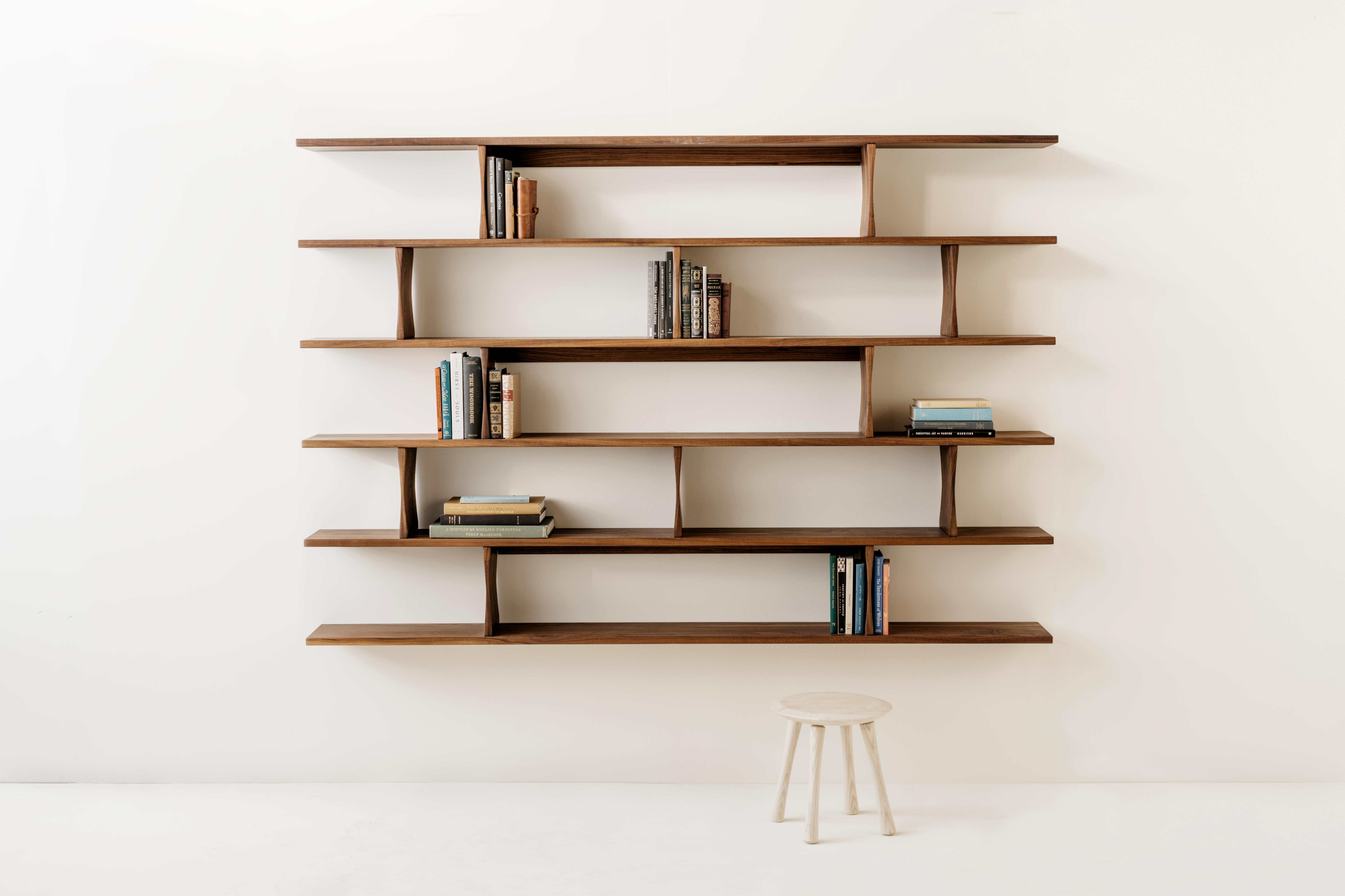 Richard Watson wall-mounted bookshelves are designed to appear as though they are floating on the wall. They are mounted with a minimal cleat system that conceals any mounting hardware, allowing the form of the shelves to be uninterrupted. The
