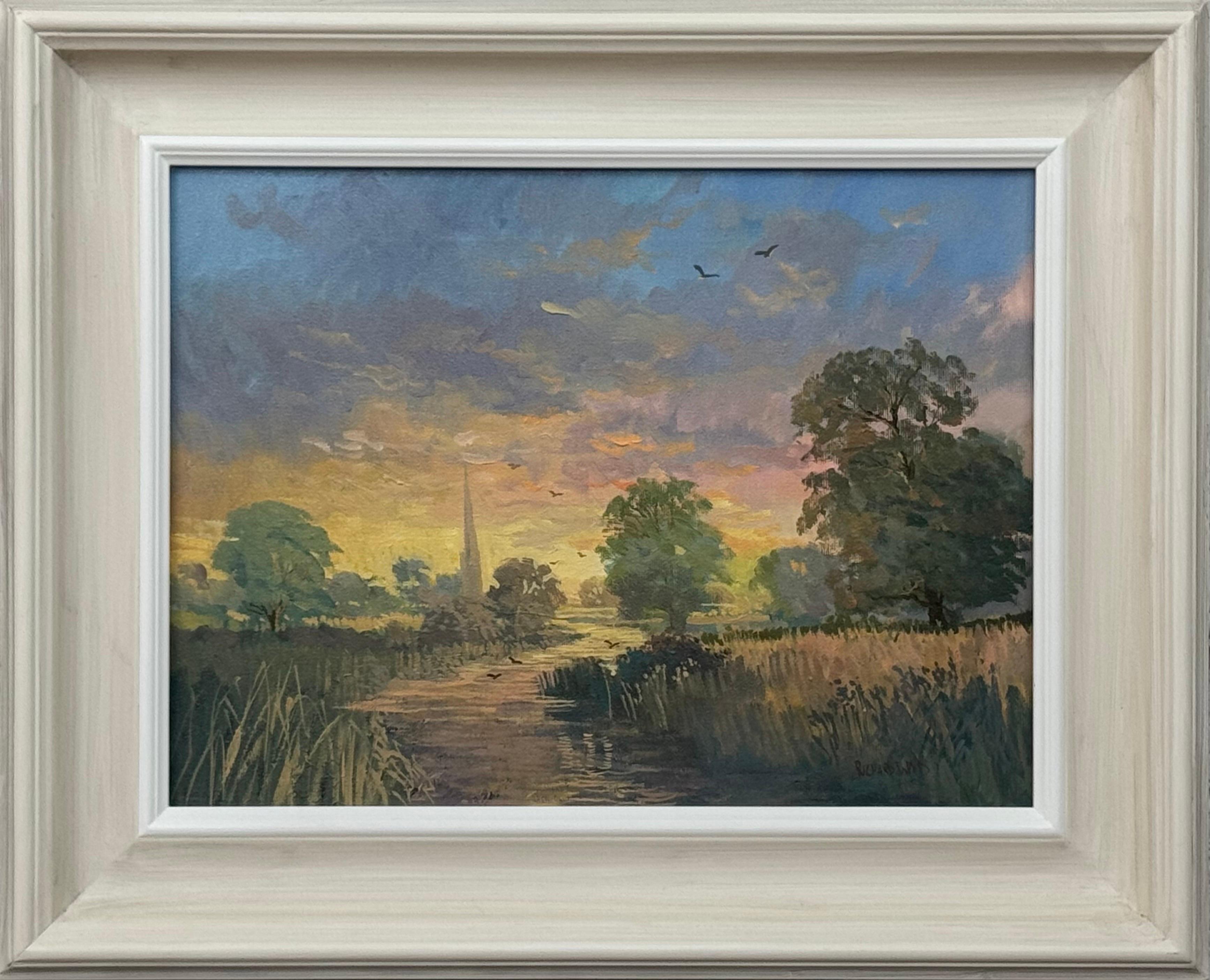 Lever de soleil sur un village au bord d'une rivière dans la campagne anglaise avec la flèche d'une église et des oiseaux