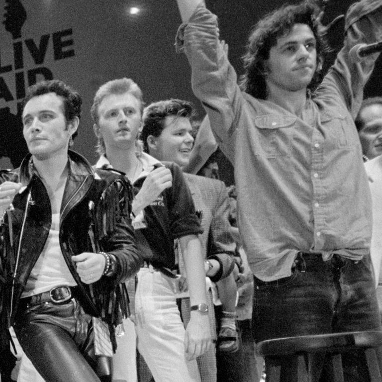 Bono, McCartney, Freddie, Bowie, Adam Ant & Geldof, Live Aid, Wembley, 1985 - Gray Black and White Photograph by Richard Young