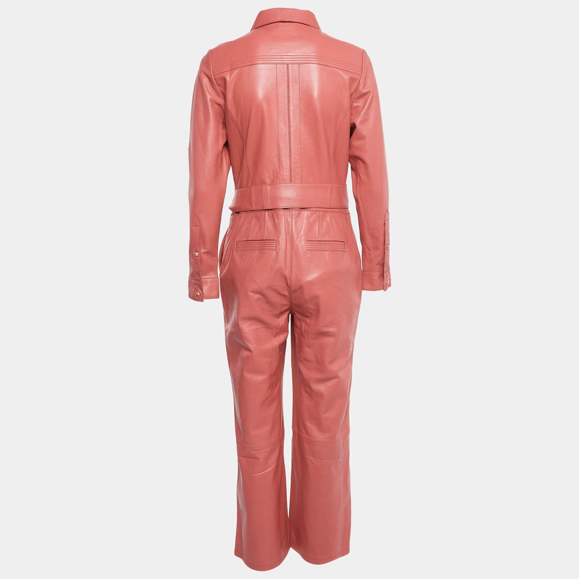 The Richards Radcliffe jumpsuit is a chic and bold fashion statement. Crafted from luxurious pink leather, it features a stylish cropped silhouette and a flattering belted waist. This jumpsuit seamlessly combines edgy and feminine elements for a