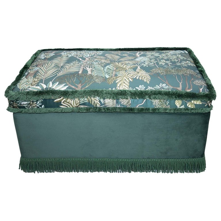 Suiting both classic and modern environments, the opulent Richie Pouf is upholstered in green velvet with a matching fringe trim. The upper part is a comfortable cushion covered with a floral patterned silk fabric also in shades of green. This
