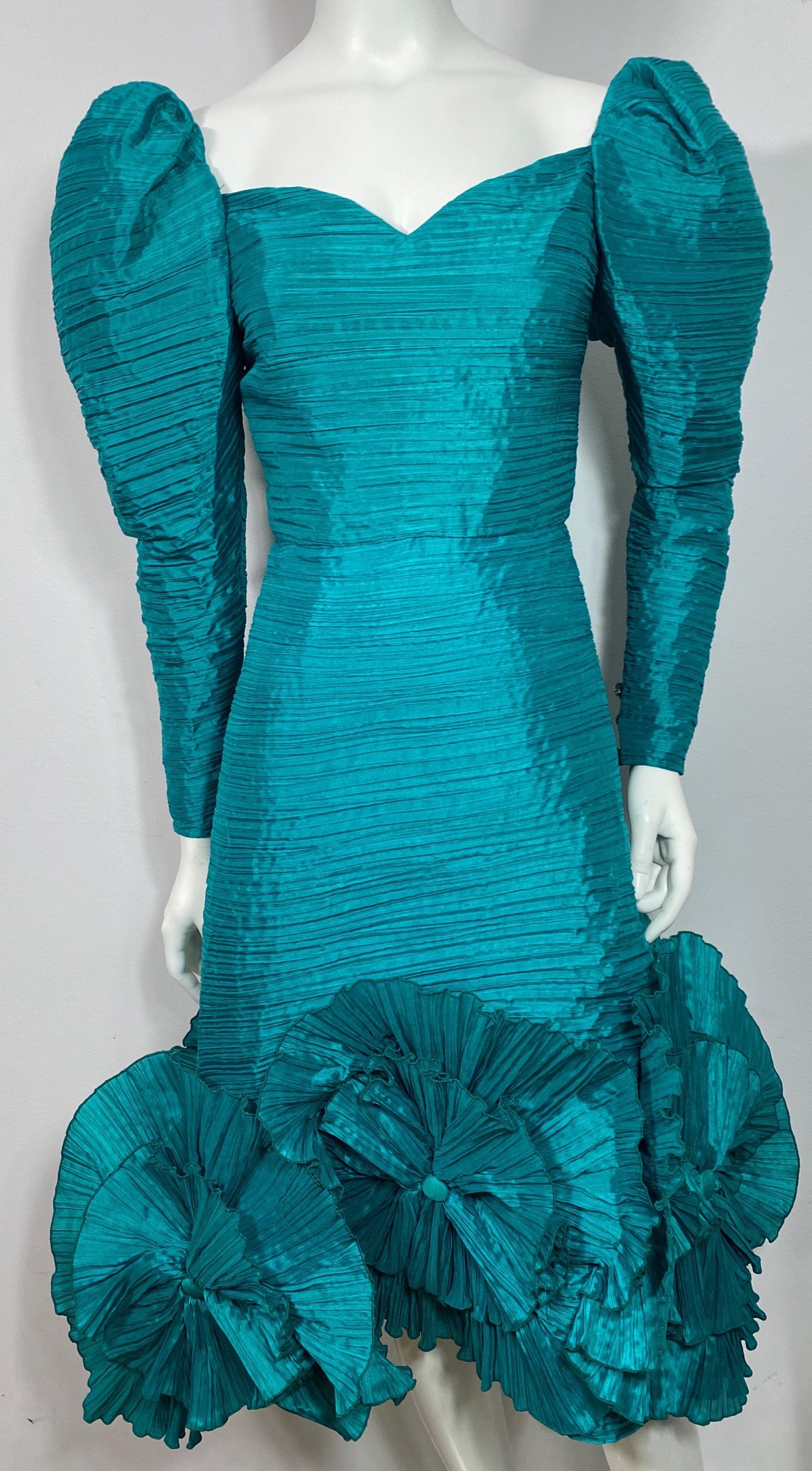 Richilene 1990’s Emerald Green Pleated Silk Dress-Size 4. This 1990’s Richilene creation is made of a fabulous emerald green pleated silk taffeta, has a sweetheart neckline, Balloon sleeves that narrow towards the wrist with 3 rhinestone buttons.
