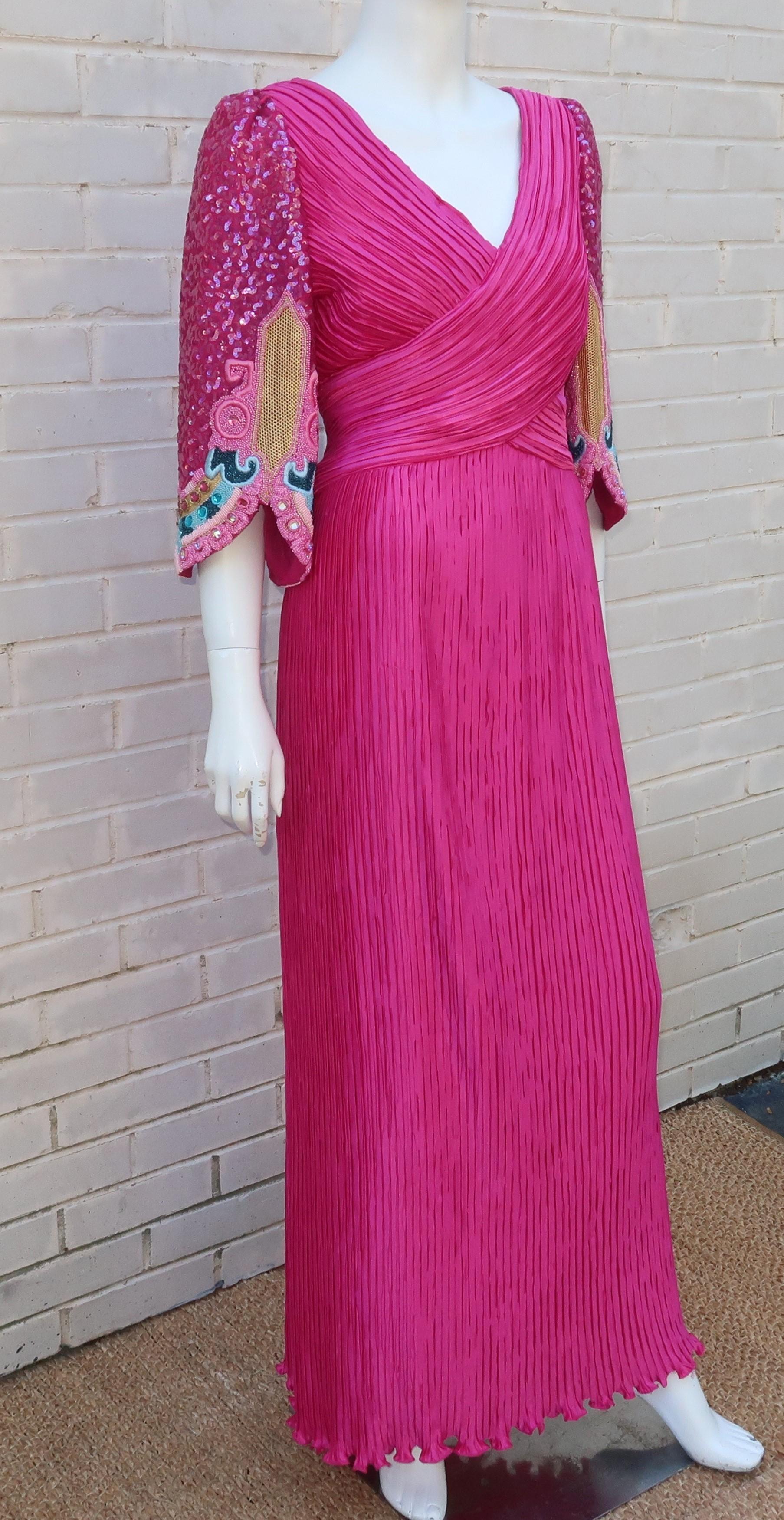 The bright fuchsia color of this 1980’s Richilene evening dress is captivating though the phenomenal bead work on the sleeves is the real show stopper.  Beautifully made with a micro pleat fabric reminiscent of Mary McFadden or Mario Fortuny, the