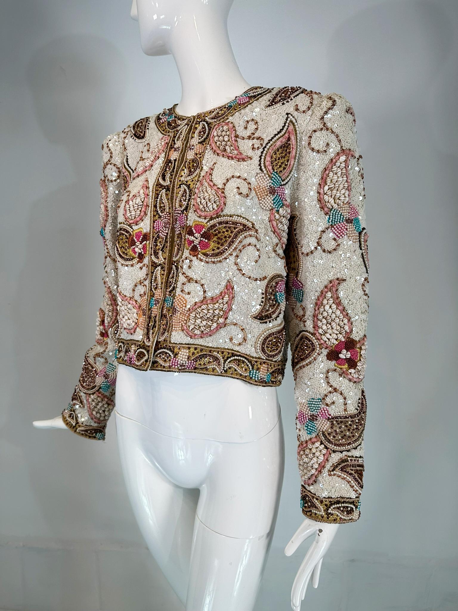 Richilene heavily beaded evening jacket with sea shells, beads, sequins, this amazing jacket is done in a paisley design with metallic cord work which outlines the boteh shapes that are filled in with shells, beads or sequins. Over all it has a