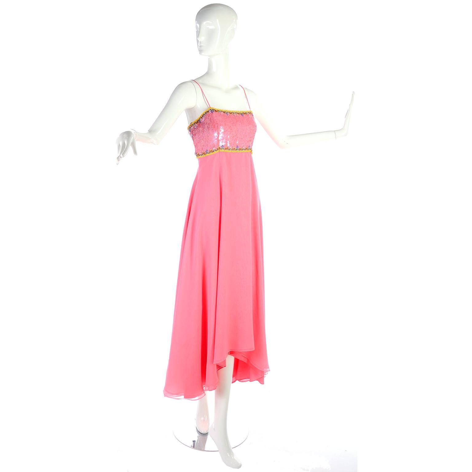 This is a lovely vintage dress from Richilene with long double layers of pink chiffon with an asymmetrical hem that comes with a beautiful jacket with beads and sequins.. The late 1970's or early 1980's evening gown has spaghetti straps and a