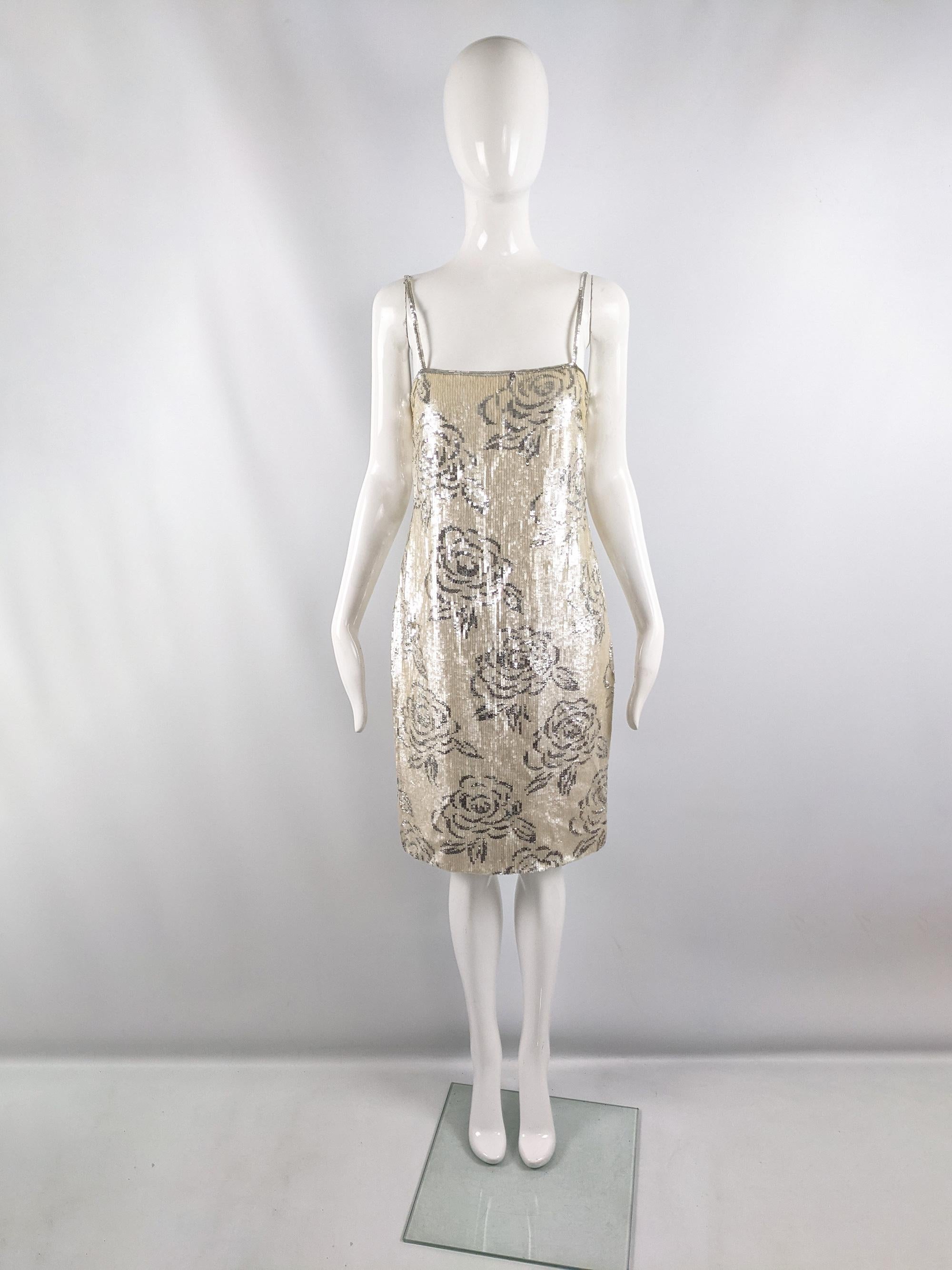 A glamorous vintage party shift dress from the 80s by luxury American fashion label, Richilene. In fully sequinned fabric with cream and silver sequins creating a glamorous floral print throughout. It has cute spaghetti straps, loose waist and a