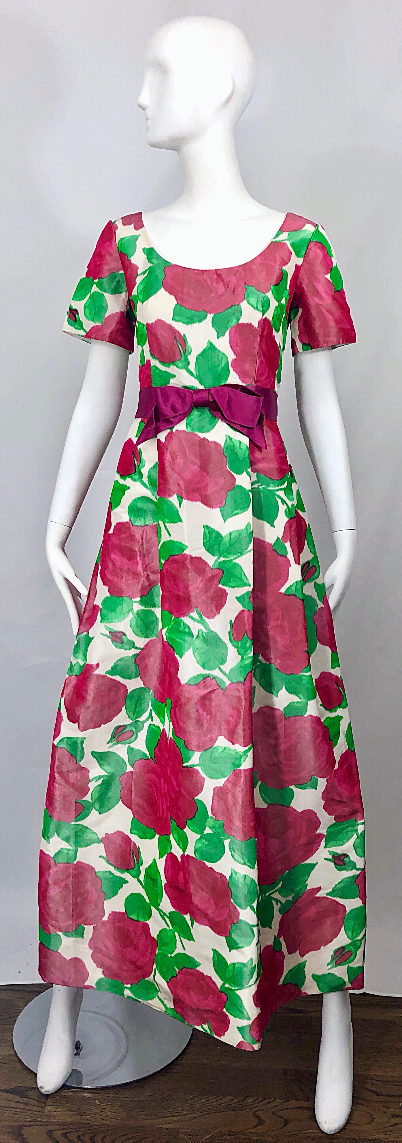 Beautiful vintage 1970s RICHILENE for ELIZABETH ARDEN silk taffeta 3-D rose print short sleeve couture gown! Features bold rose prints in vibrant hot pink and green. Tailored bodice with a forgiving full bell skirt. Fuchsia silk velvet attached bow