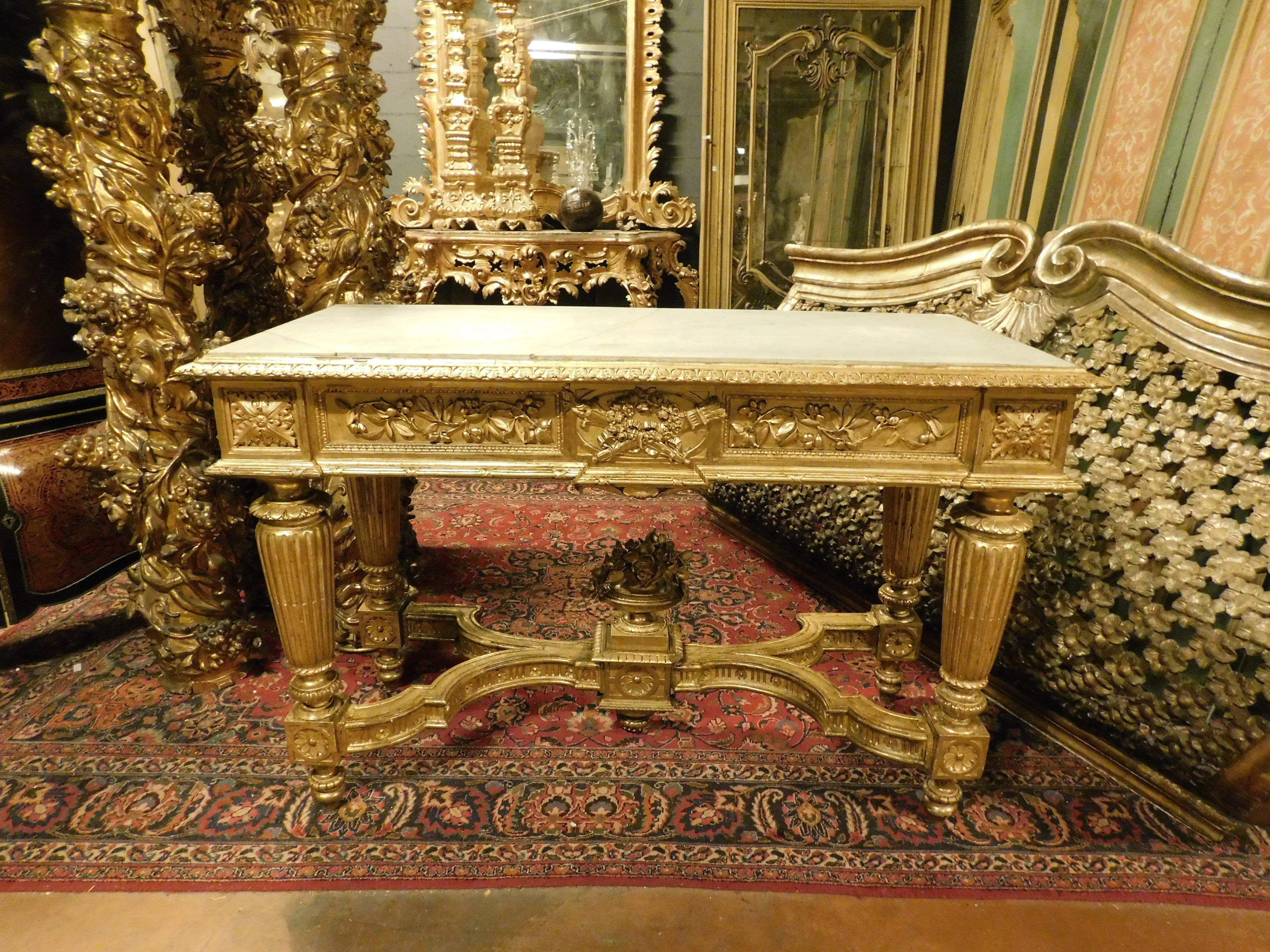 Antique console table, in wood richly hand carved with columns, festoons and leaf motifs and enriched with precious gilding, complete with contemporary white marble top and cross legs of very fine workmanship. Original from the 18th century, coming