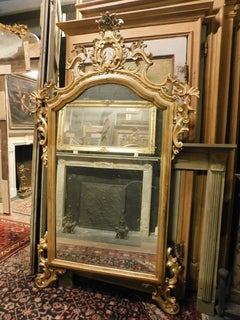 Richly carved and gilded wooden mirror, Italy