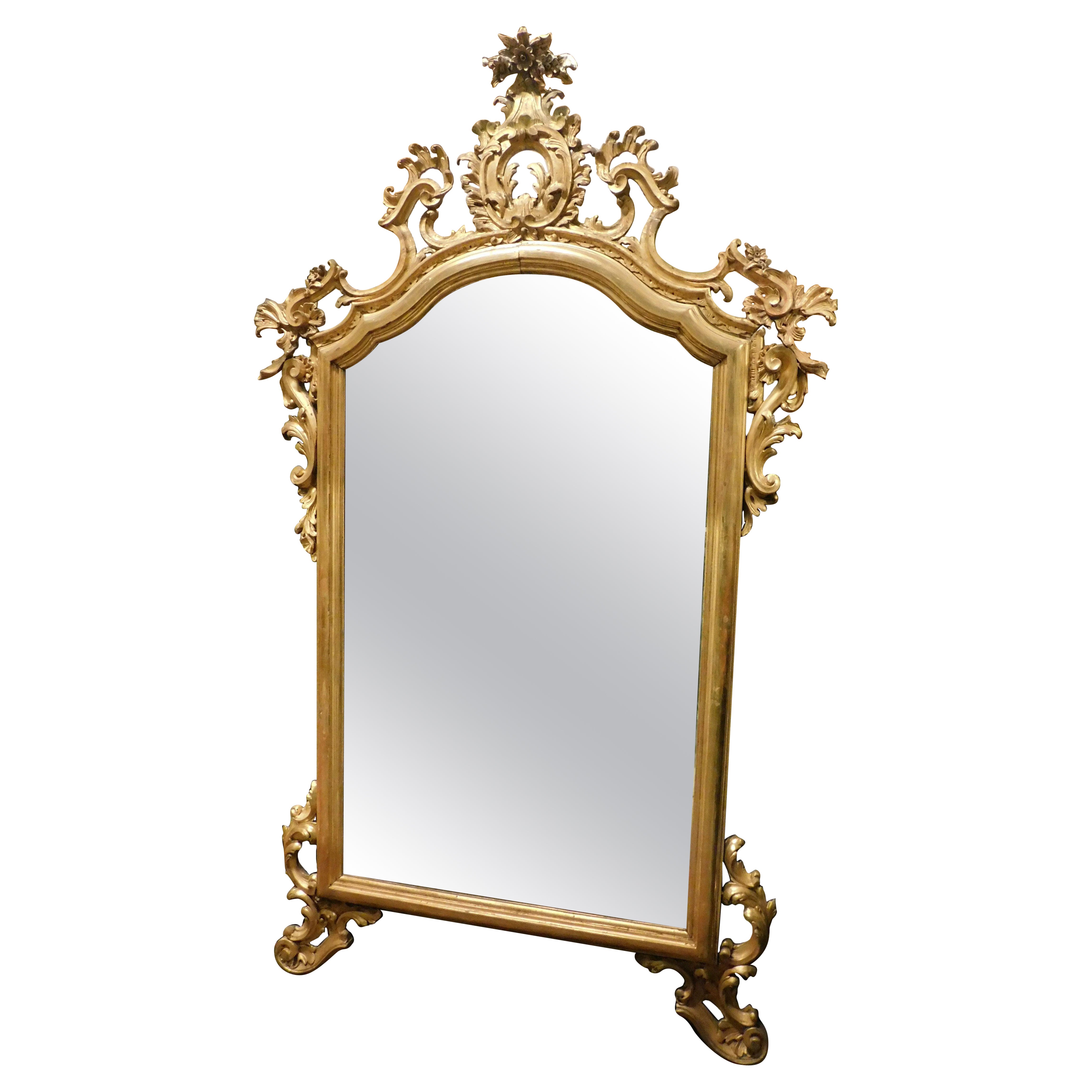 Richly carved and gilded wooden mirror, Italy