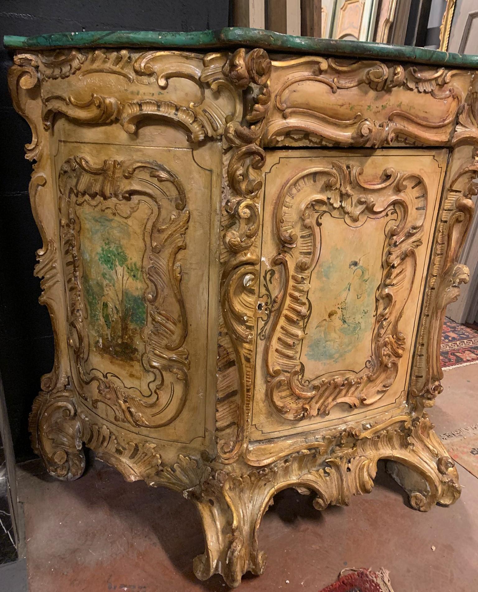 Antique vintage Credenza, richly carved and painted sideboard, baroque style but from the early 1900s, convoluted shape and one door, vintage and from Italy. Lacquered top in faux marble.
Maximum dimensions w 135 x h 115 x d 60 cm
