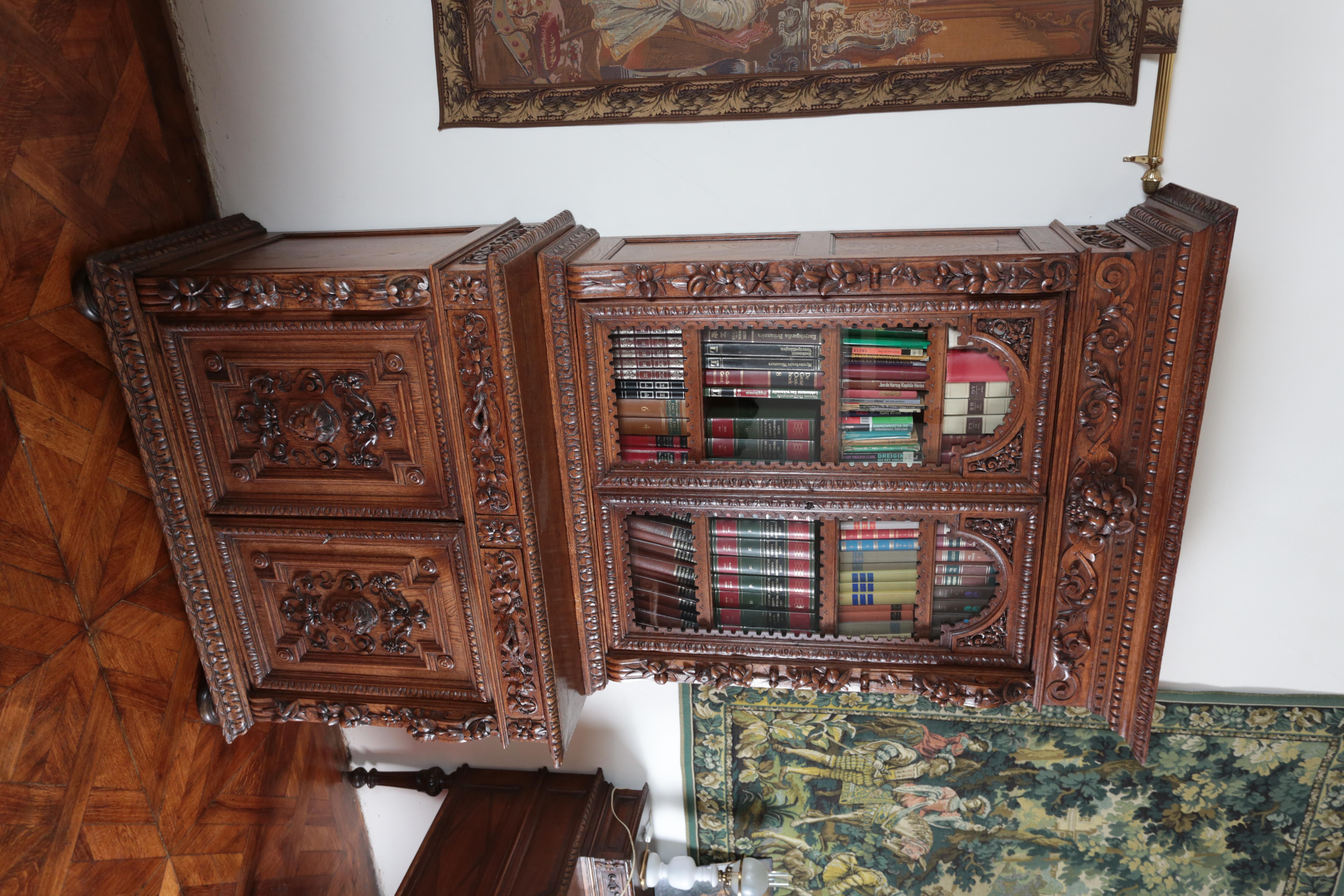Solid oak sideboard richly carved in the Renaissance style. Precise carving work from the second half of the 19th century. Choice oak. The sideboard / bookcase consists of two parts: an upper glazed chaat with adjustable shelves, a lower part with