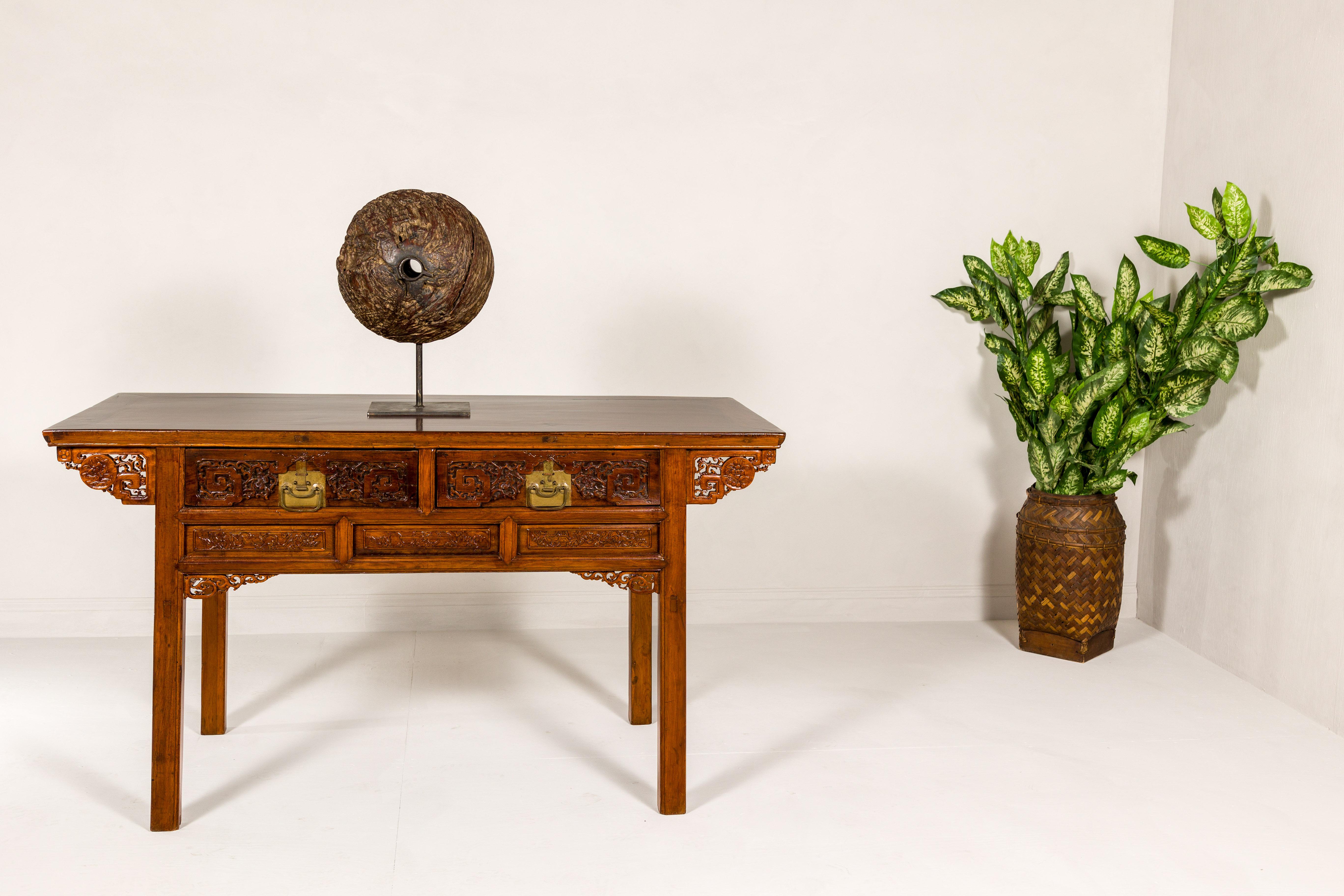 A richly carved console table with two drawers, scrolling clouds and flowers. An exquisitely detailed masterpiece, this vintage console table invites you into a world of ethereal beauty, richly carved with a tableau of scrolling clouds and blooming