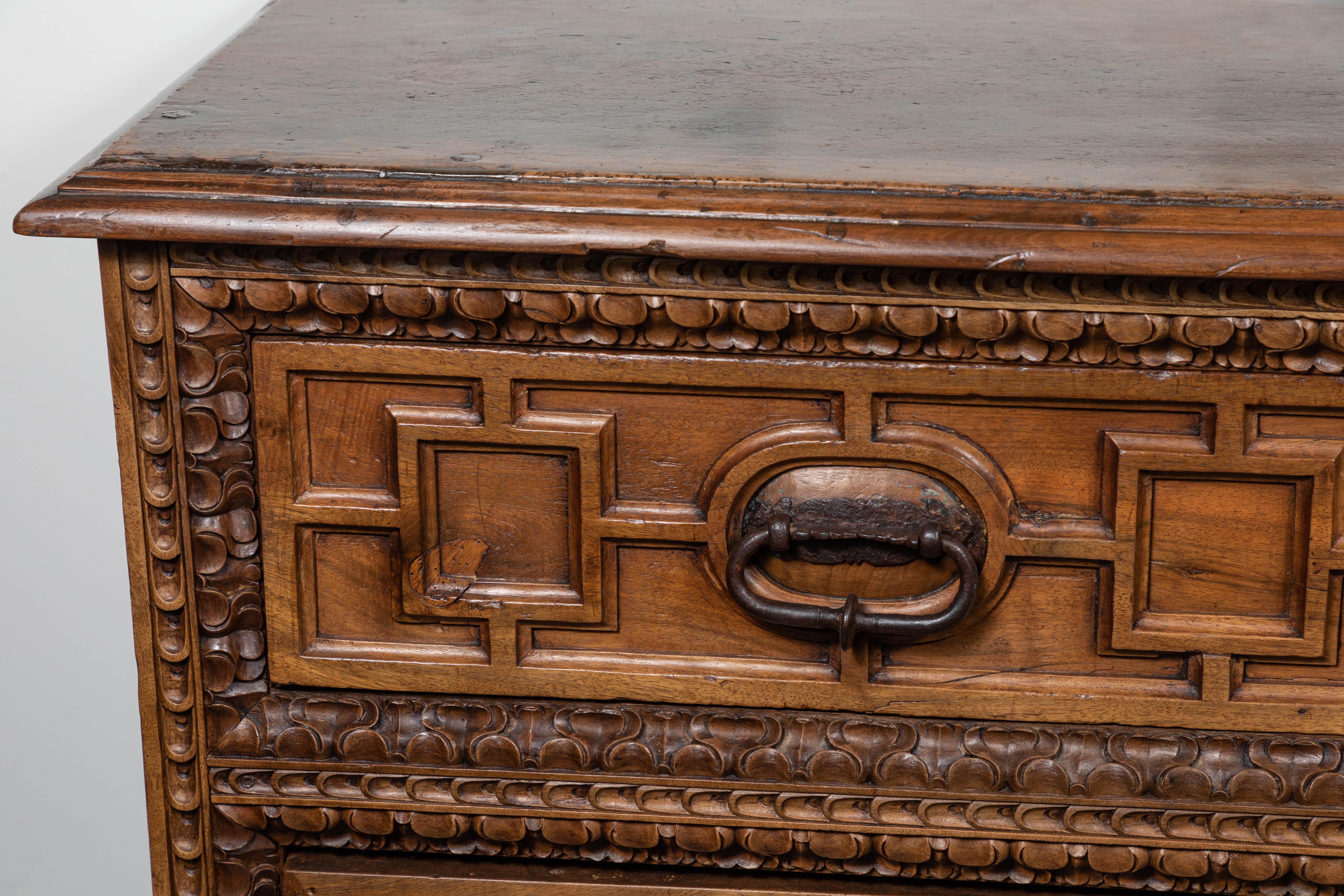 An 18th century, bleached oak, three drawer commode from Spain. Wonderful, coffered sides flank the relief drawers which are surrounded by a mix of stylized bands. This piece features its original, cast iron hardware.