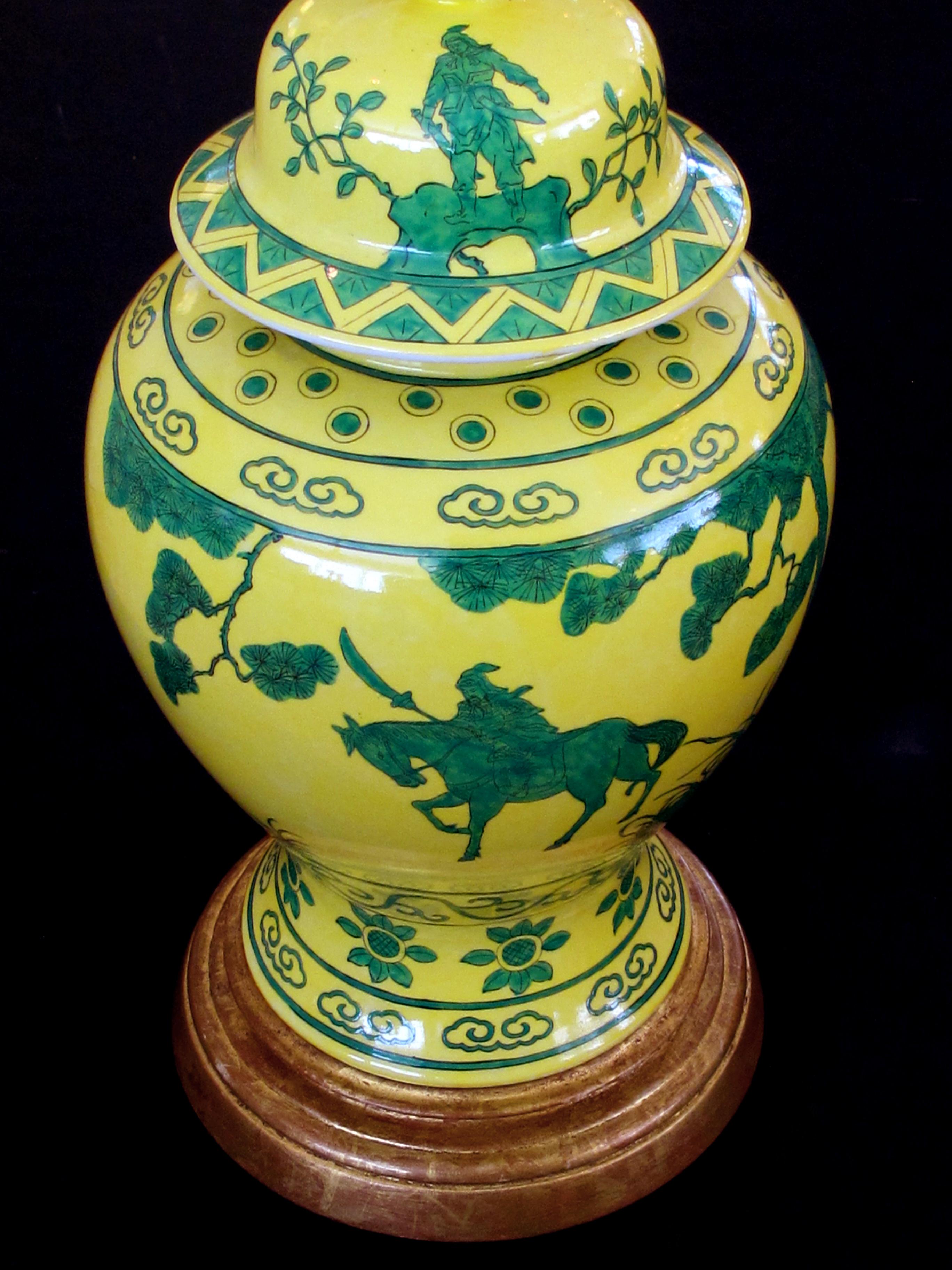 A stunning and richly-colored pair of mid-century Japanese canary yellow ginger jars with dark green decoration now mounted as lamps; stamped; each richly-colored porcelain ginger jar of canary yellow with a dark green decoration of a warrior with
