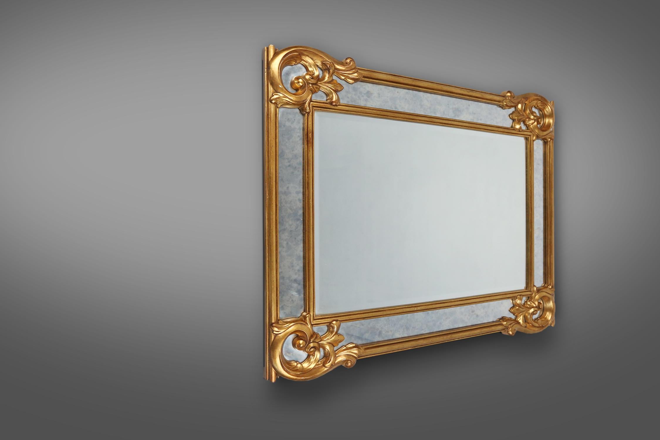 Mid-Century Modern Richly decorated wall mirror in resin with golden ornaments and smoked mirror gl For Sale