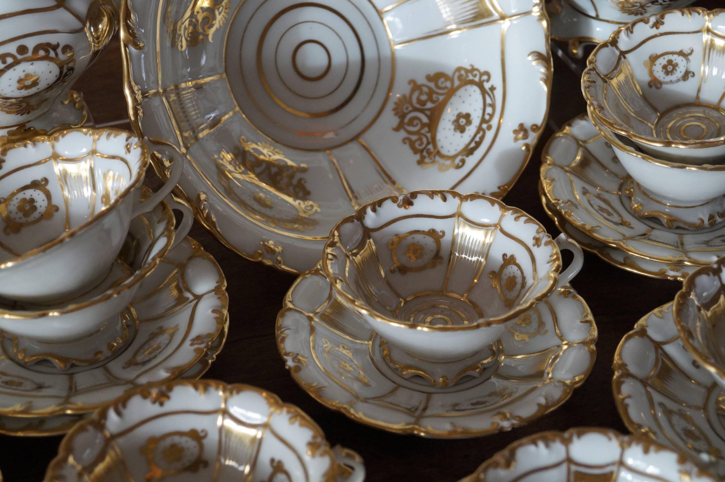 Richly gold decorated Old Paris porcelain tea service
France, circa 1880

Good condition. No wear and some very minor damage on some cups.

Measure: Teapot diameter 25cm - 19cm high 
Sugarpot diameter 17cm - high 16.5cm 
Creamer diameter 13cm