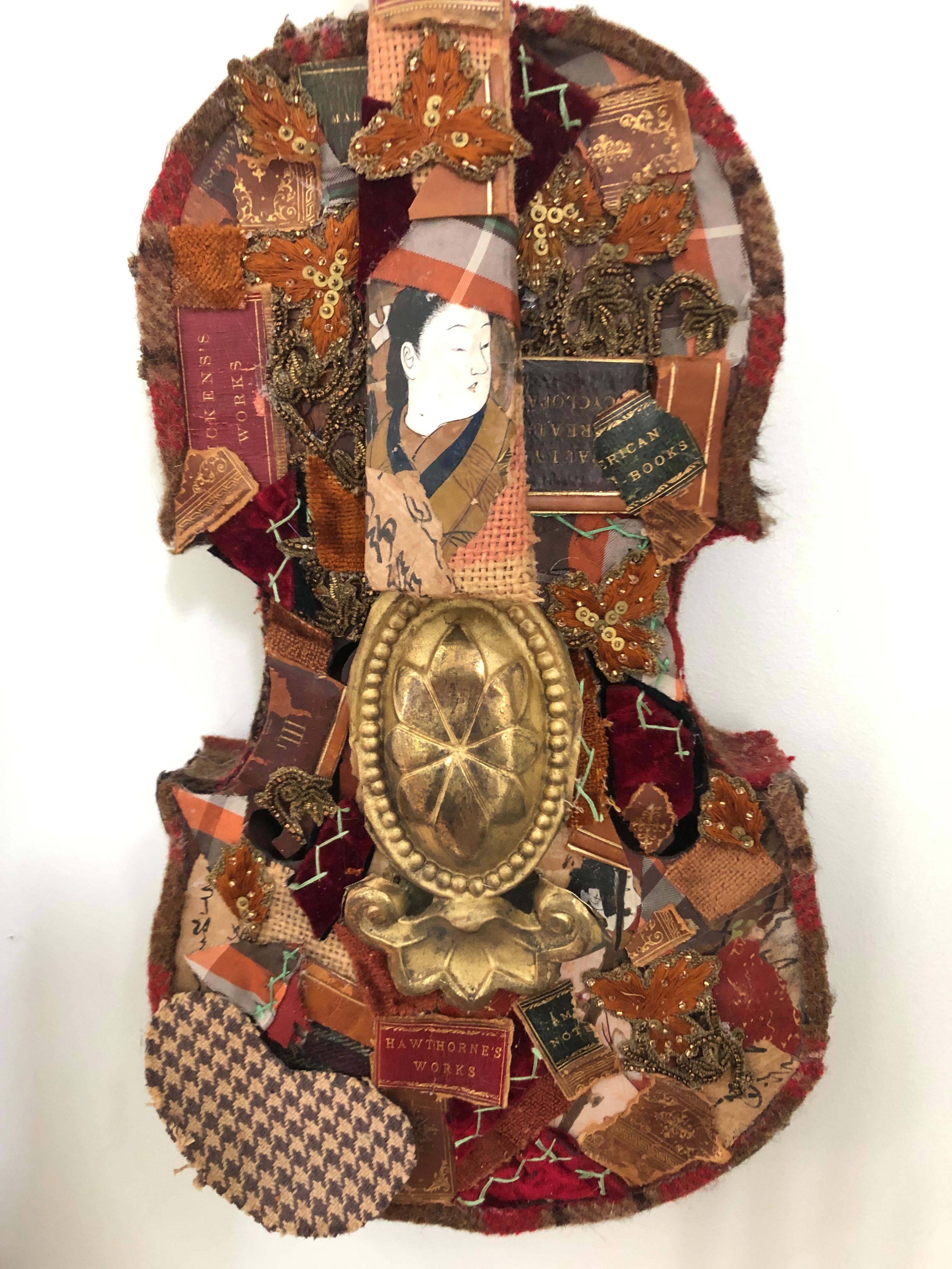 A rich mixed-media collage on an antique violin having meticulously layered paper ephemera with a Japanese motife, leather book bindings, bits and pieces from a crazy quilt, vintage trimmings and tin cutout. A splendid wall sculpture in brown, gold,