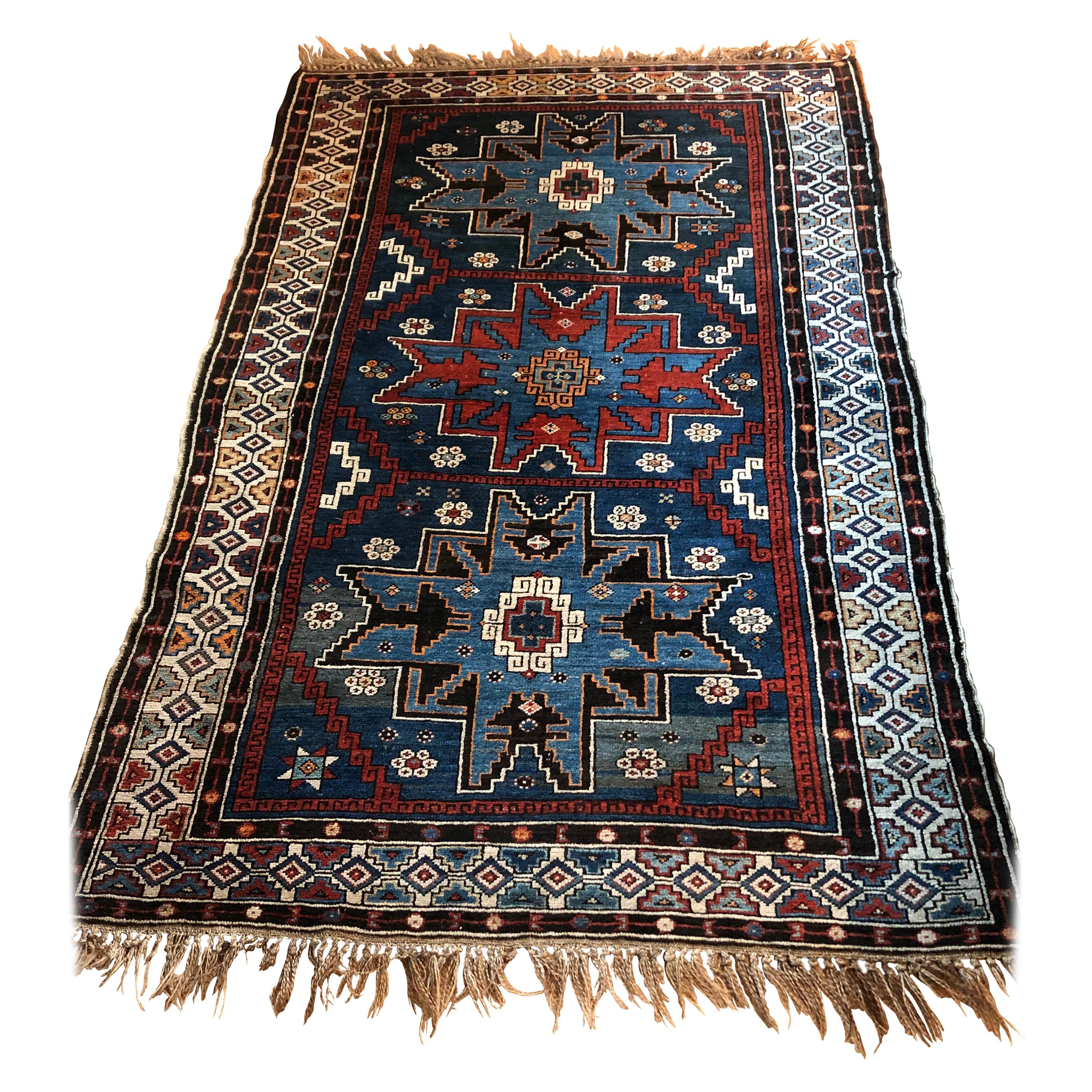 Richly Patterned Antique Area Rug in Blues and Cranberry