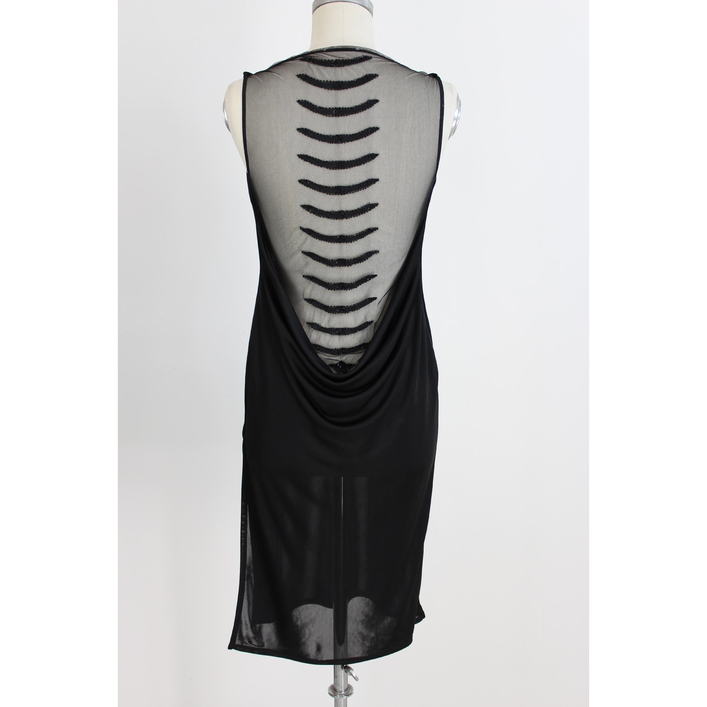 Richmond long evening dress for women. Black colour. Strapless dress with soft neckline, along the back deep necklines with transparencies and plays of black sequins. The neckline along the back measures 55 cm. Made in Italy. Excellent vintage