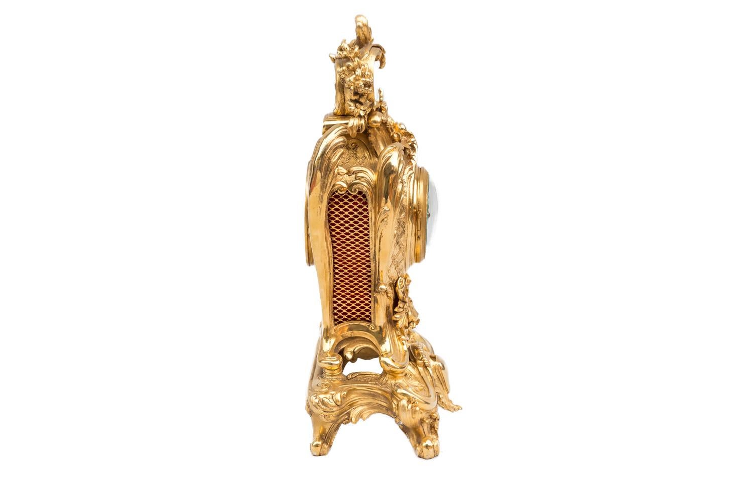 Benoît Félix Richond, signed.

Rocaille style gilt bronze clock.
Tumultuous case in a stylized cartouche shape standing on a scalloped base with four scrolls legs and a central cartouche decor.
Top of the case adorned with a shell crowned by a