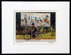 Havana, Cuba Daily Life Color Photograph of Cyclist Passing a Vintage Billboard