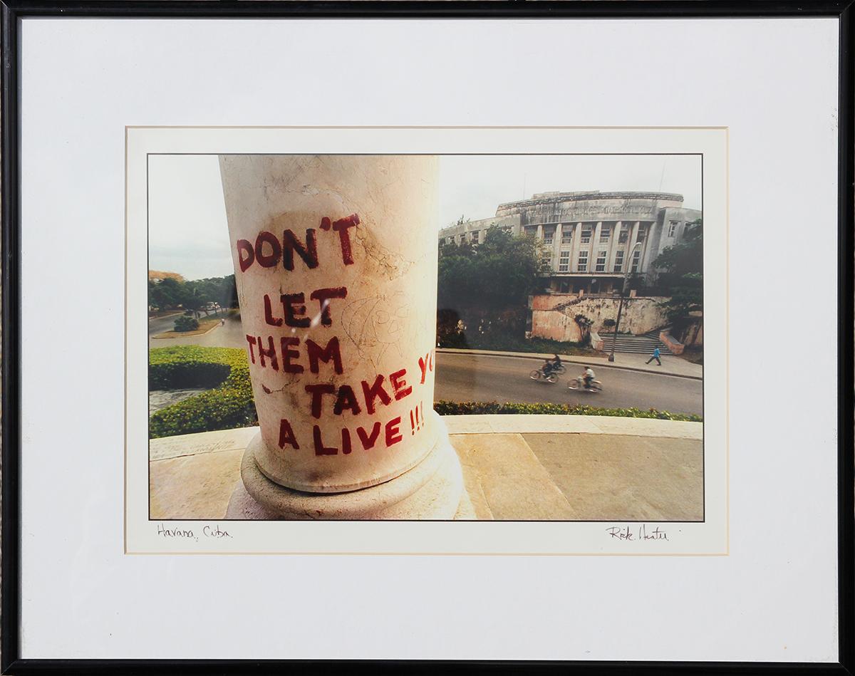 Rick Hunter Color Photograph - Havana, Cuba Daily Life Photograph of "Don't Let Them Take You Alive" Graffiti 