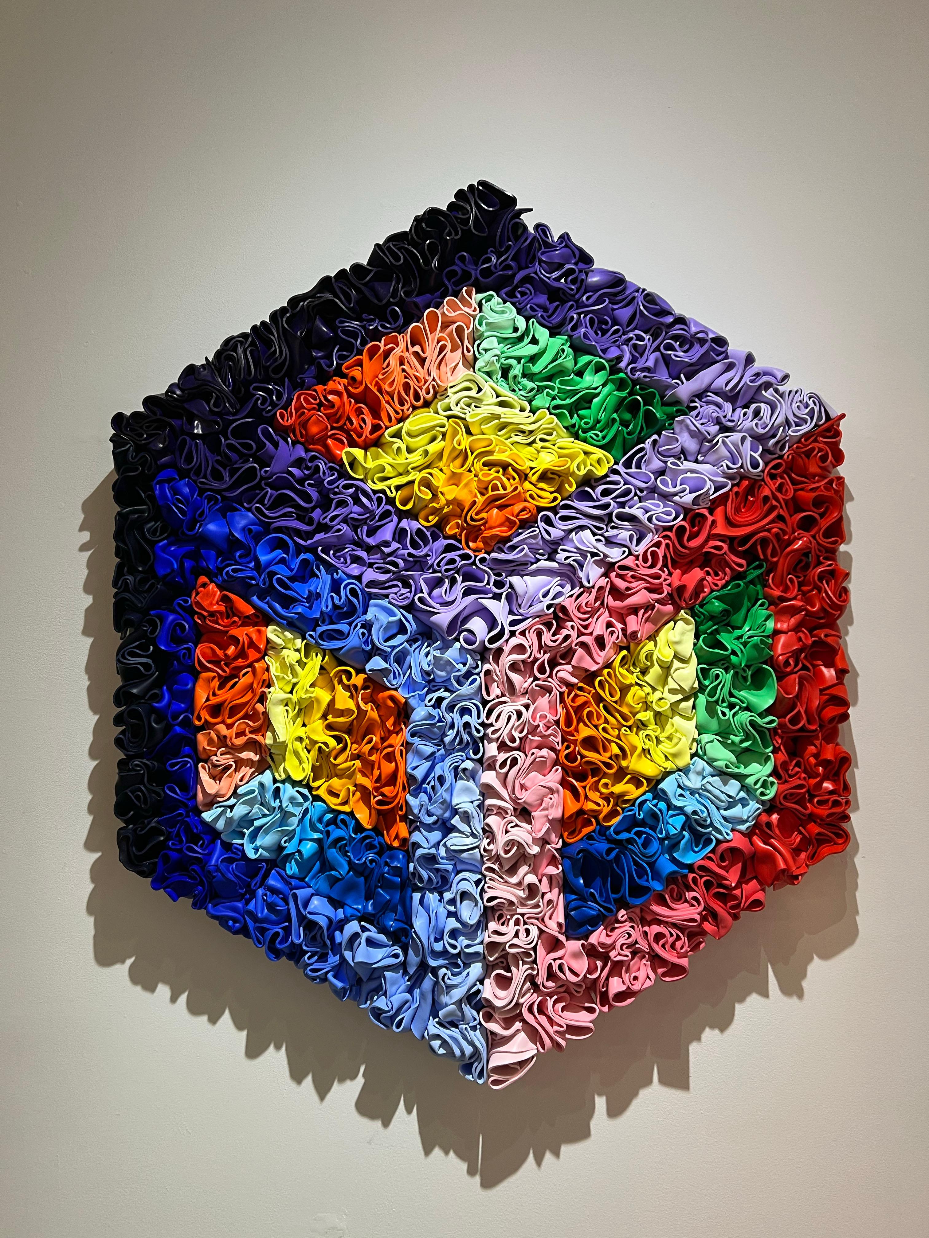 An abstract sculpture hand molded with styrene, of which creates a cubist illusion. This piece is very has very vibrant colors ranging between gradients of blues, purples, red to pink, and orange to yellow.

Rick Lazes is a three dimensional artist
