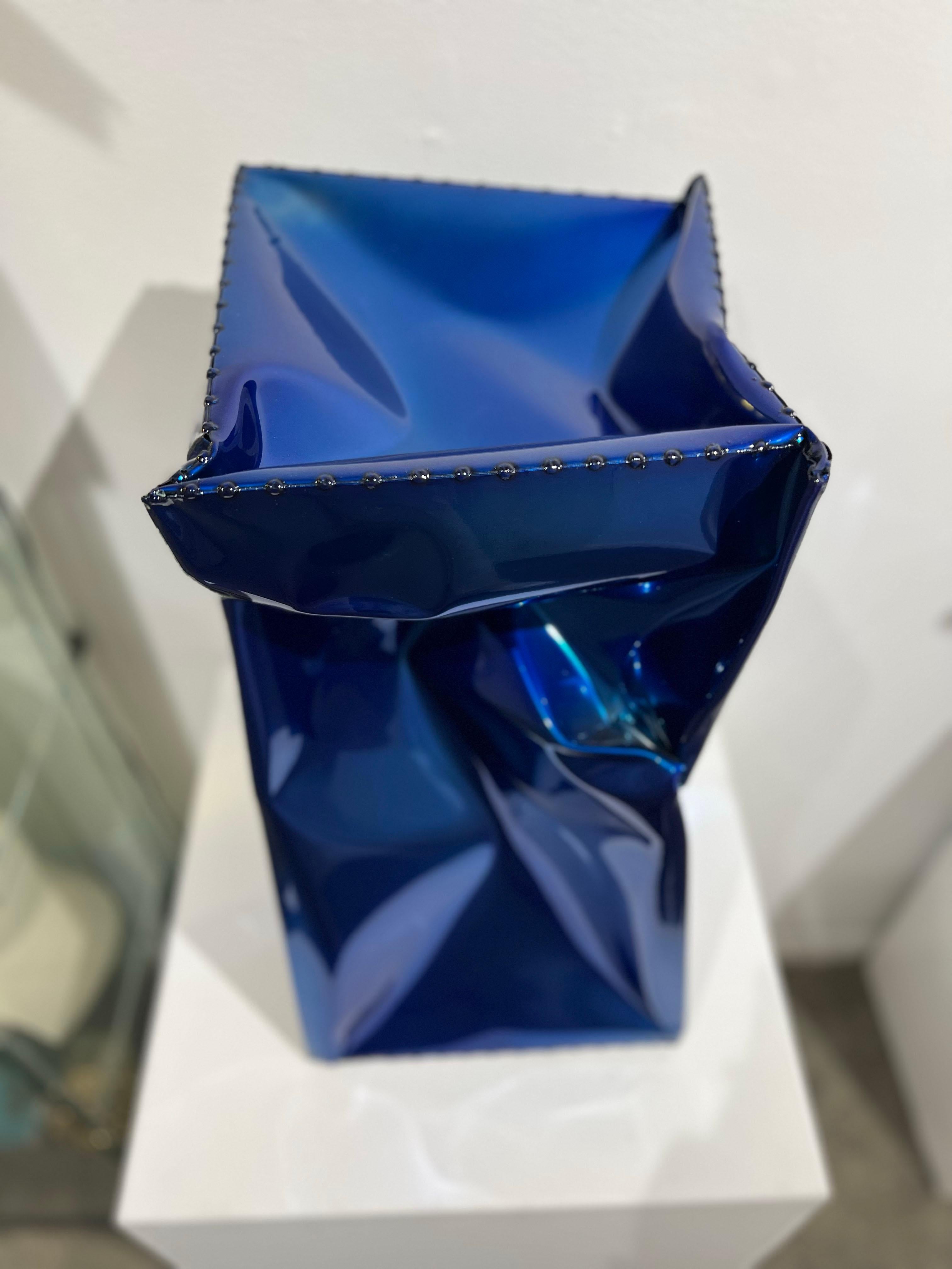 An outdoor sculpture made out of powder coated stainless steel. This sculpture is a rich, vibrant, and shiny blue. 

Rick Lazes is a three dimensional artist who works in a variety of media including wood, plaster, stainless steel, glass,