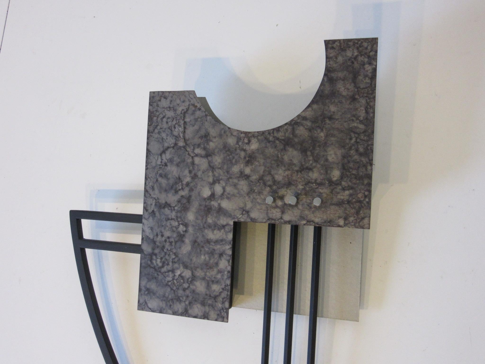 A contemporary modern abstract wall sculpture with upper light , patina art metal design , satin black rods with chrome details . To the reverse is the artist label signed by Rick Lee 1988 titled 