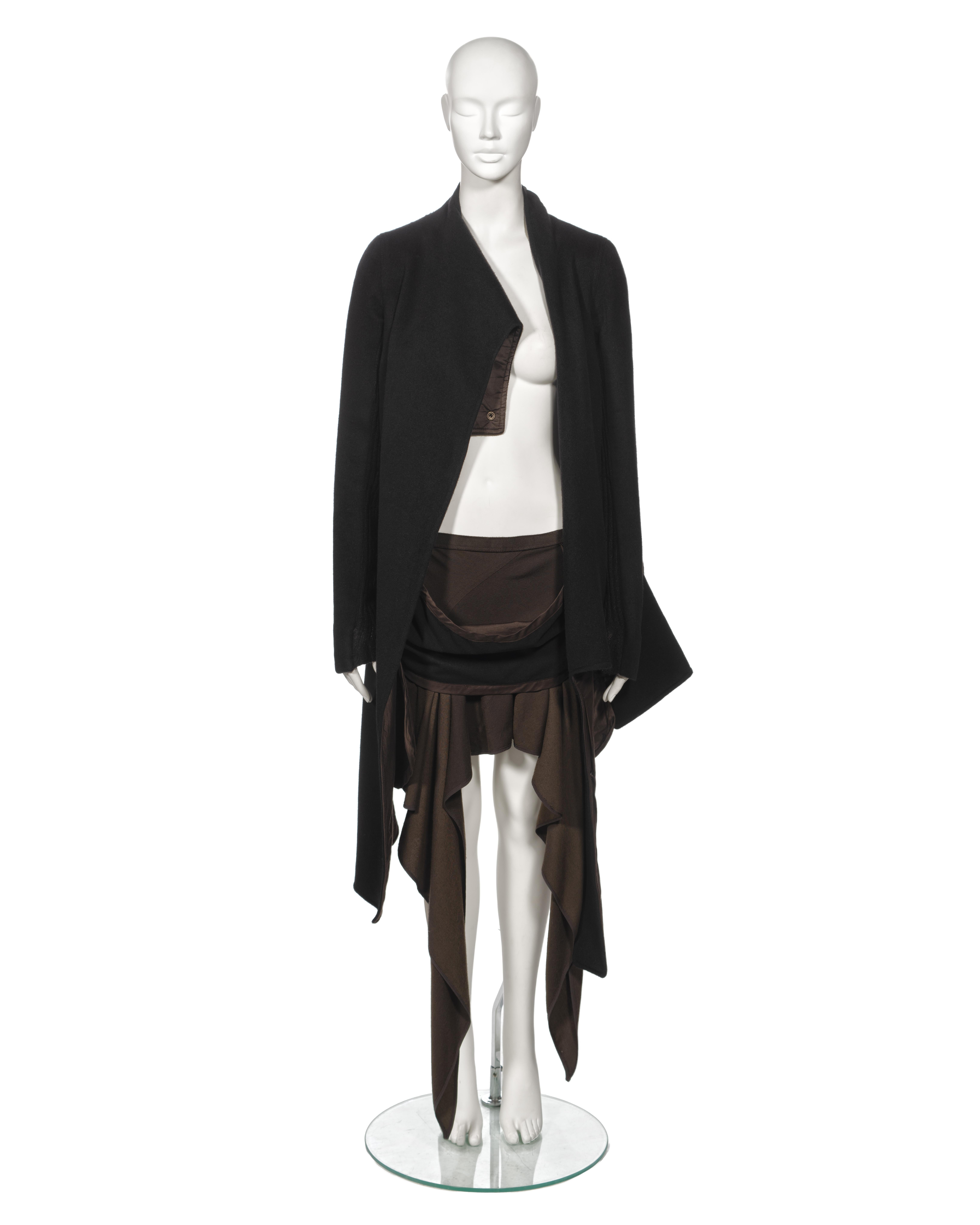 ▪ Archival Rick Owens 'Queen' Ensemble
▪ Fall-Winter 2004
▪ Asymmetric cut jacket fashioned from black Angora fabric
▪ Showcases a scarf-like attachment draped across the body, forming a generous cowl and secured at the back with metal press studs
▪