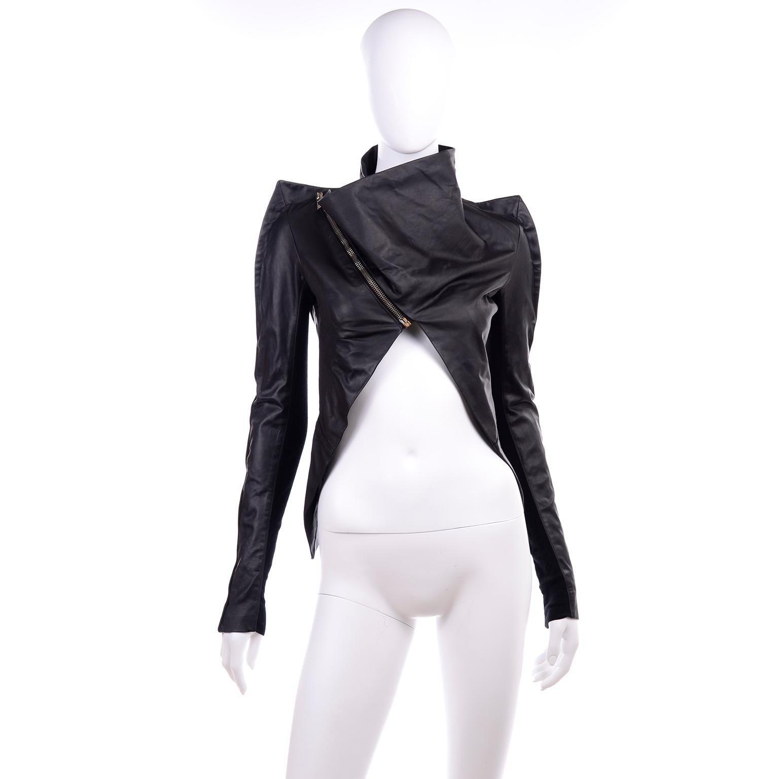 This is an iconic moto jacket from Rick Owens in black leather.  This great avant garde jacket is cut asymmetrically and appears almost like a cutaway jacket.  We love the dramatic shoulders that come to a point and give it a modern edgy look.  The
