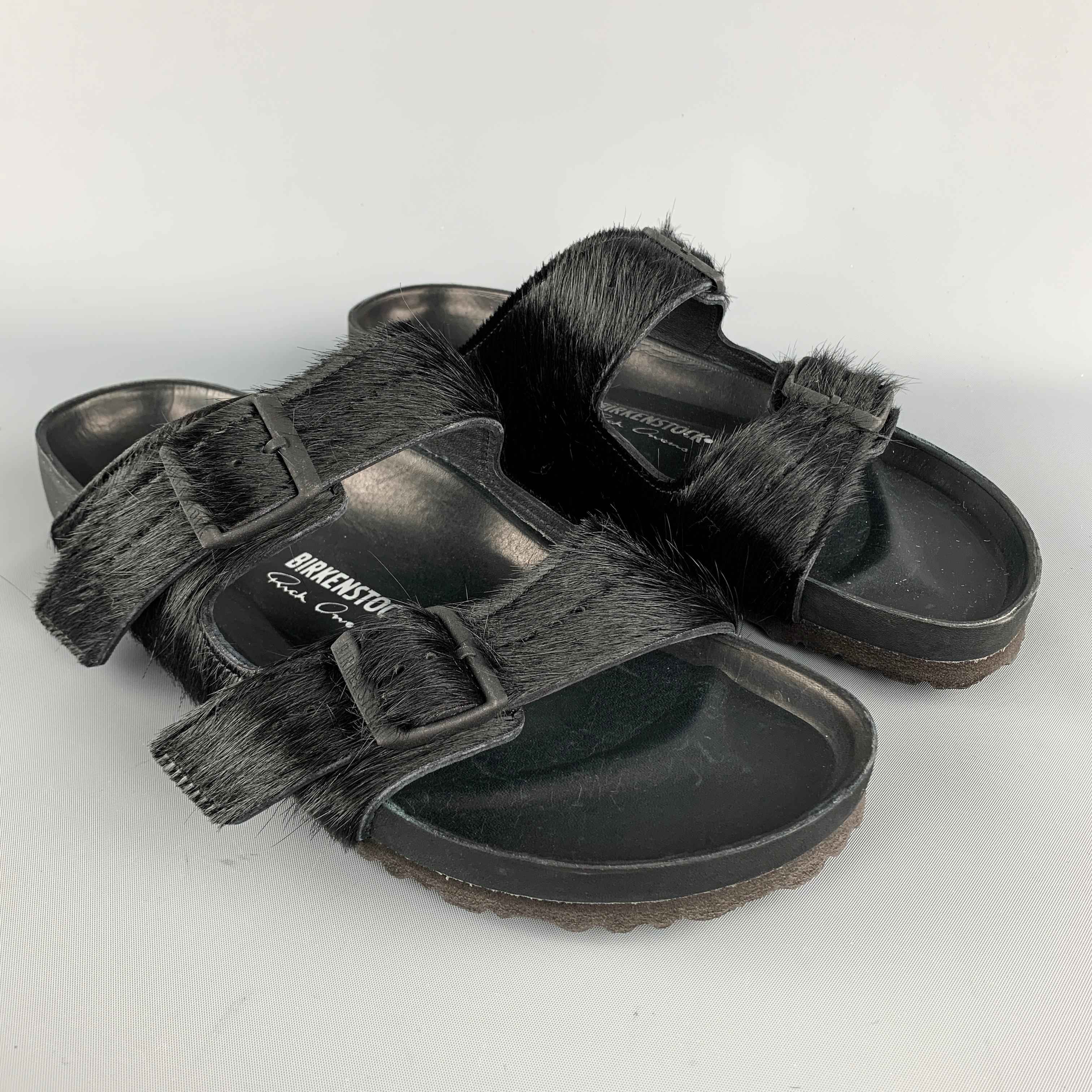 BIRKENSTOCK by RICK OWENS comes in a black textured pony hair material, double belted, with an embossed “Rick Owens” detailed insole, a black matte finish metal buckle, and a rubber sole. 

Excellent Pre-Owned Condition.
Marked: EU 44  285