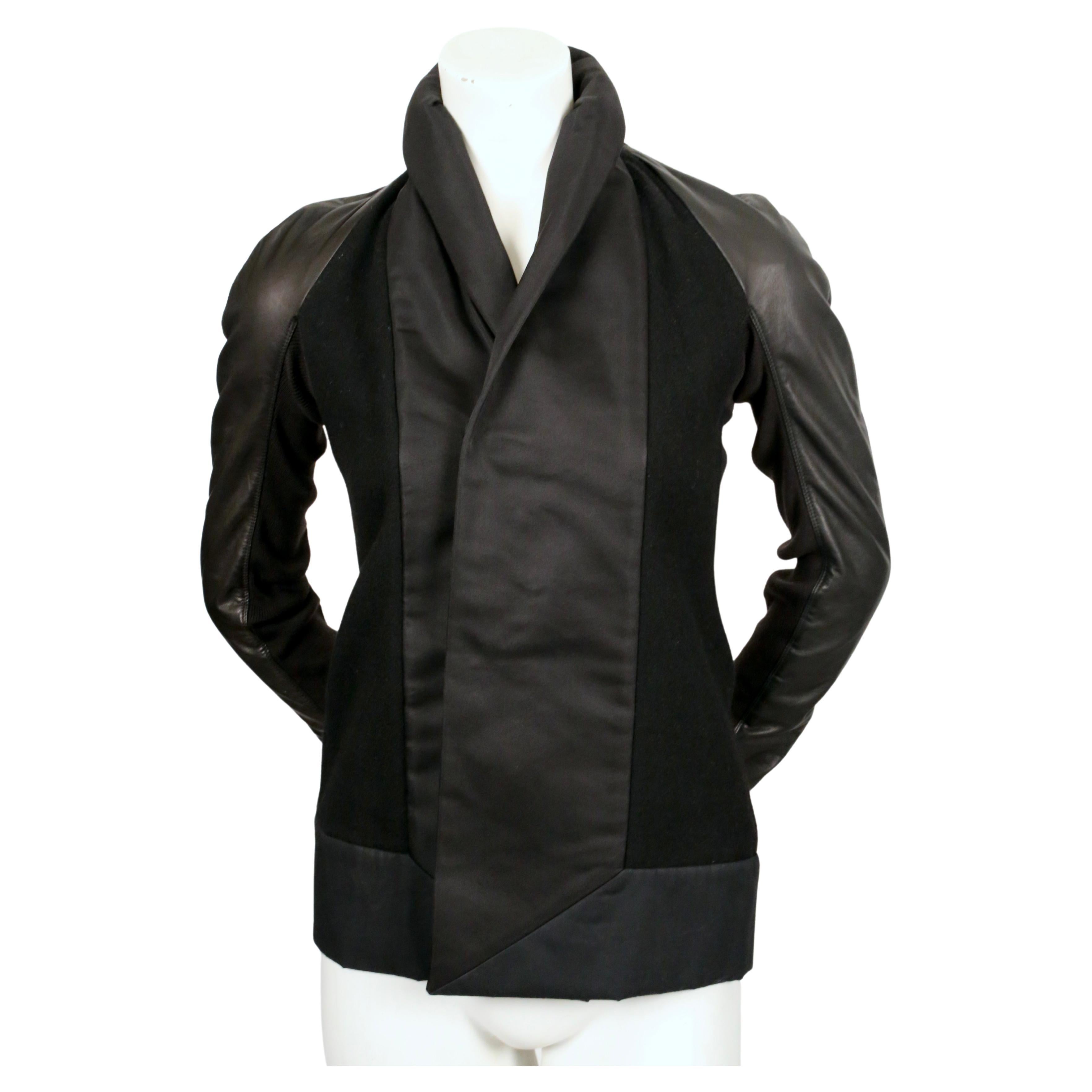 Black, soft wool jacket with satin trim and leather sleeves from Rick Owens. Italian size 38 which best fits a US 2. Approximate measurements: bust 33.5